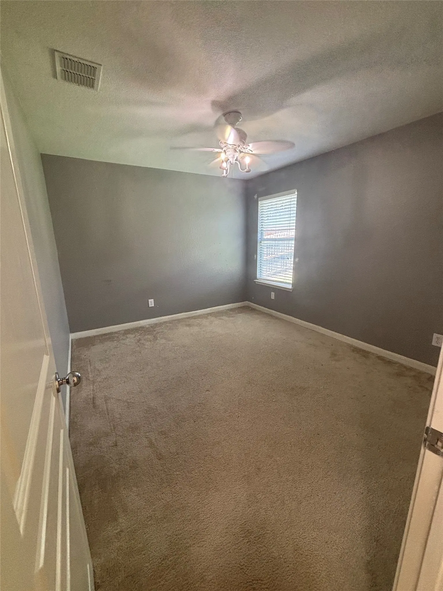 Room with vaulted ceilings and a ceiling fan