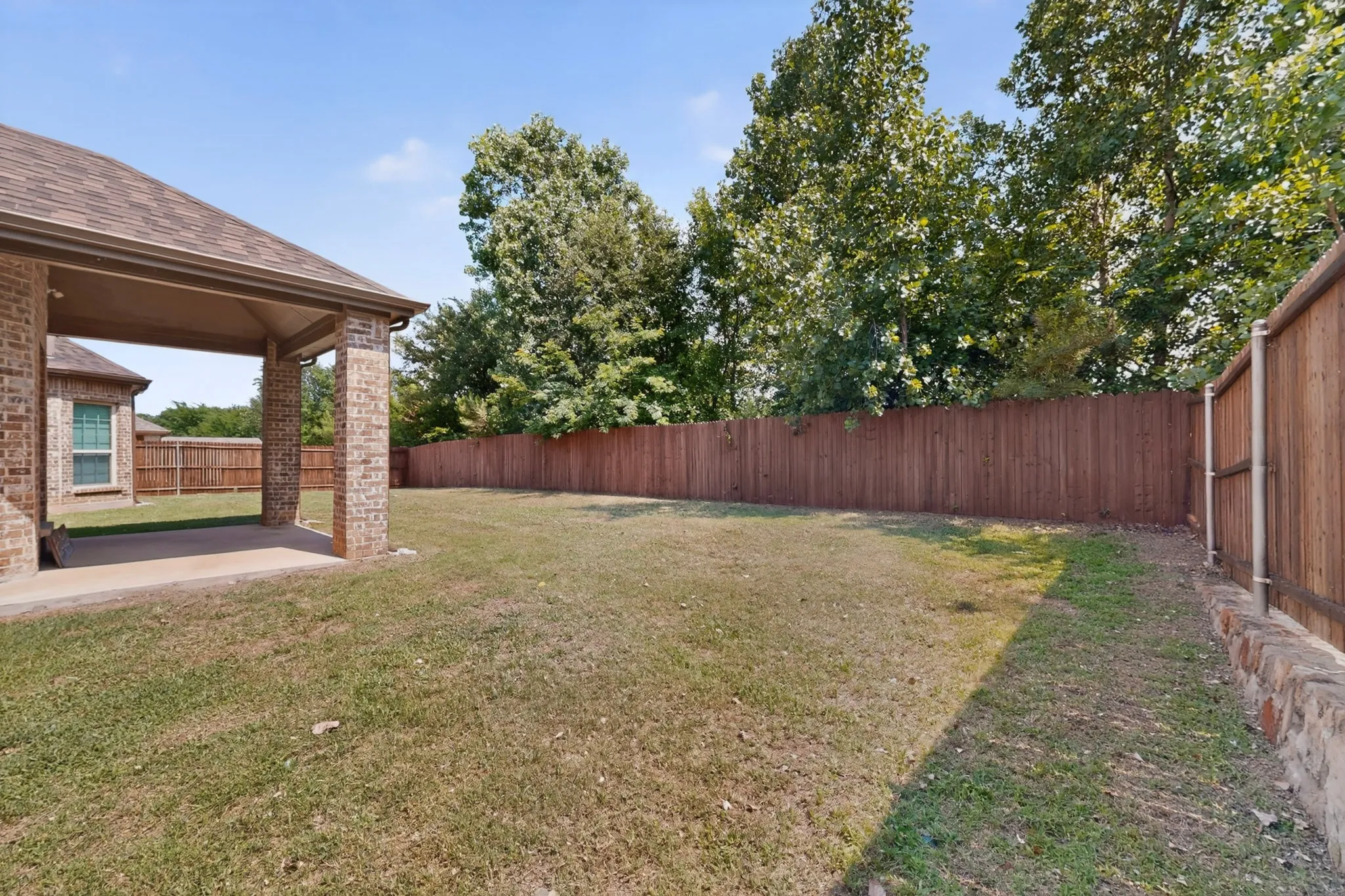 ANOTHER VIEW OF THE BIG BACKYARD,THE COVERED PATIO AND A NICE WOOD FENSE...!!!