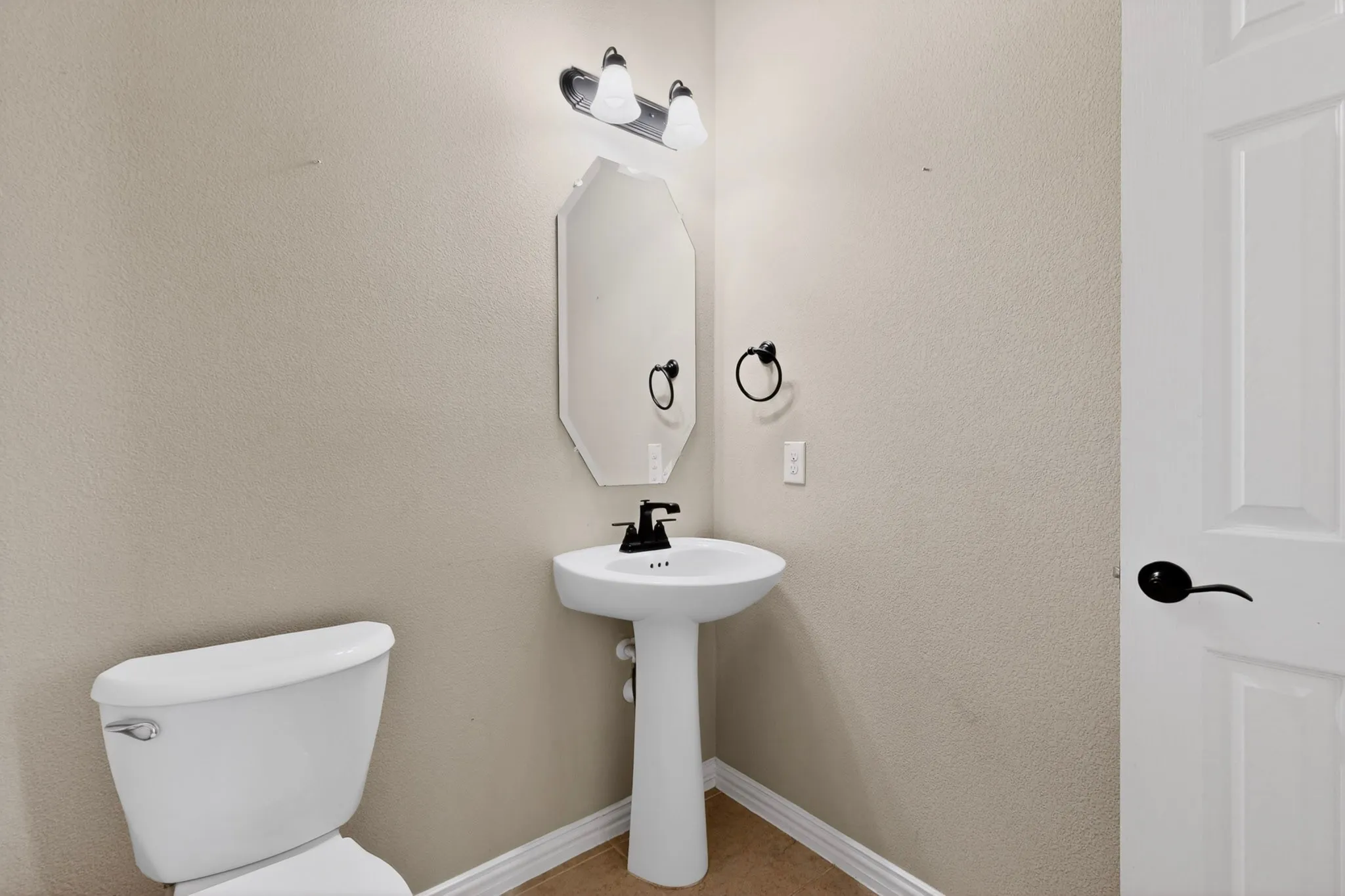 DOWNSTAIRS HALF BATH WITH LARGE LINEN CLOSET.