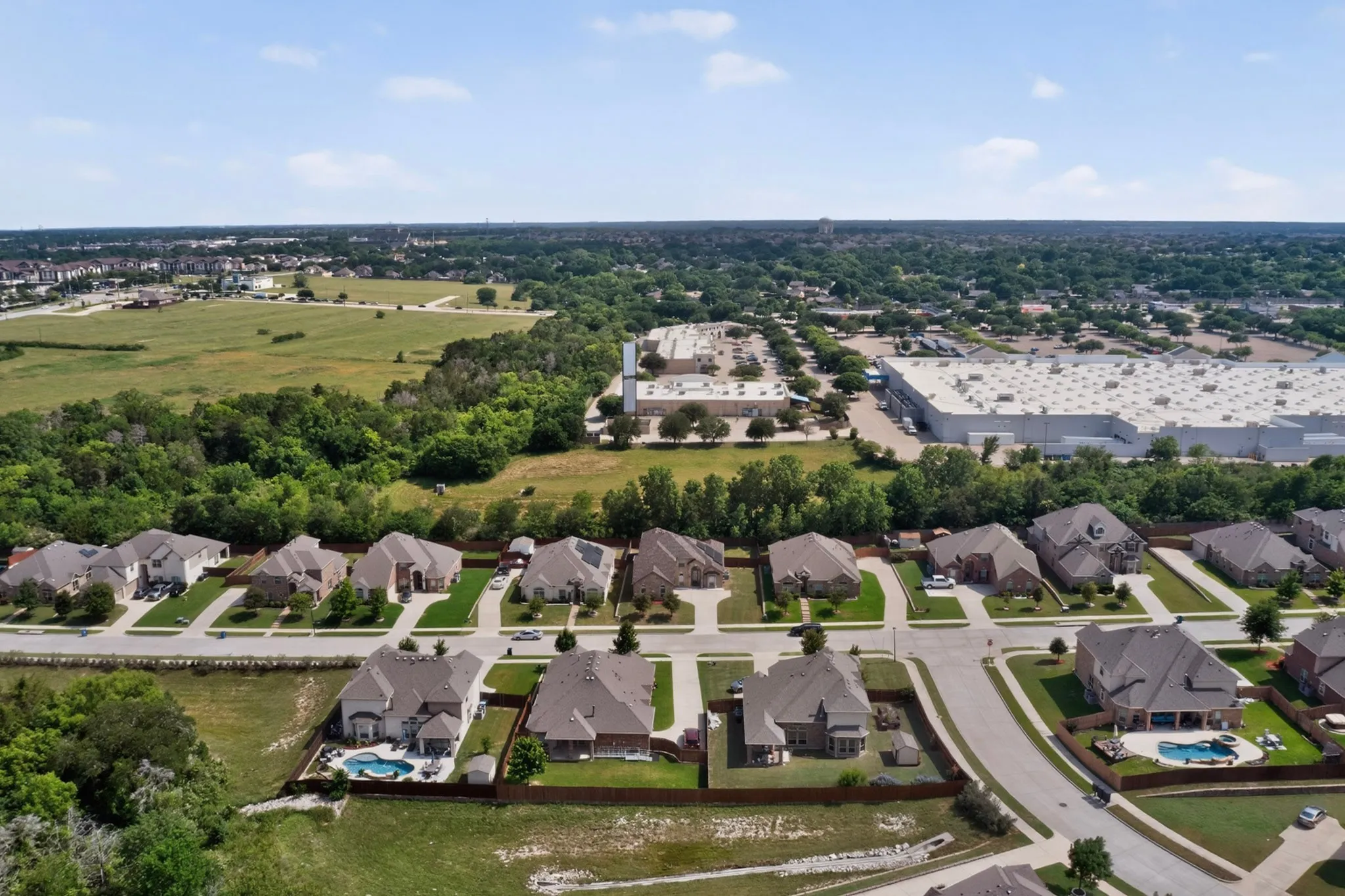 ARIEL VIEW OF THE QUIET NEIGHBORHOOD WITH NO NEIGHBORS IN THE REAR AND WIDE STREETS...