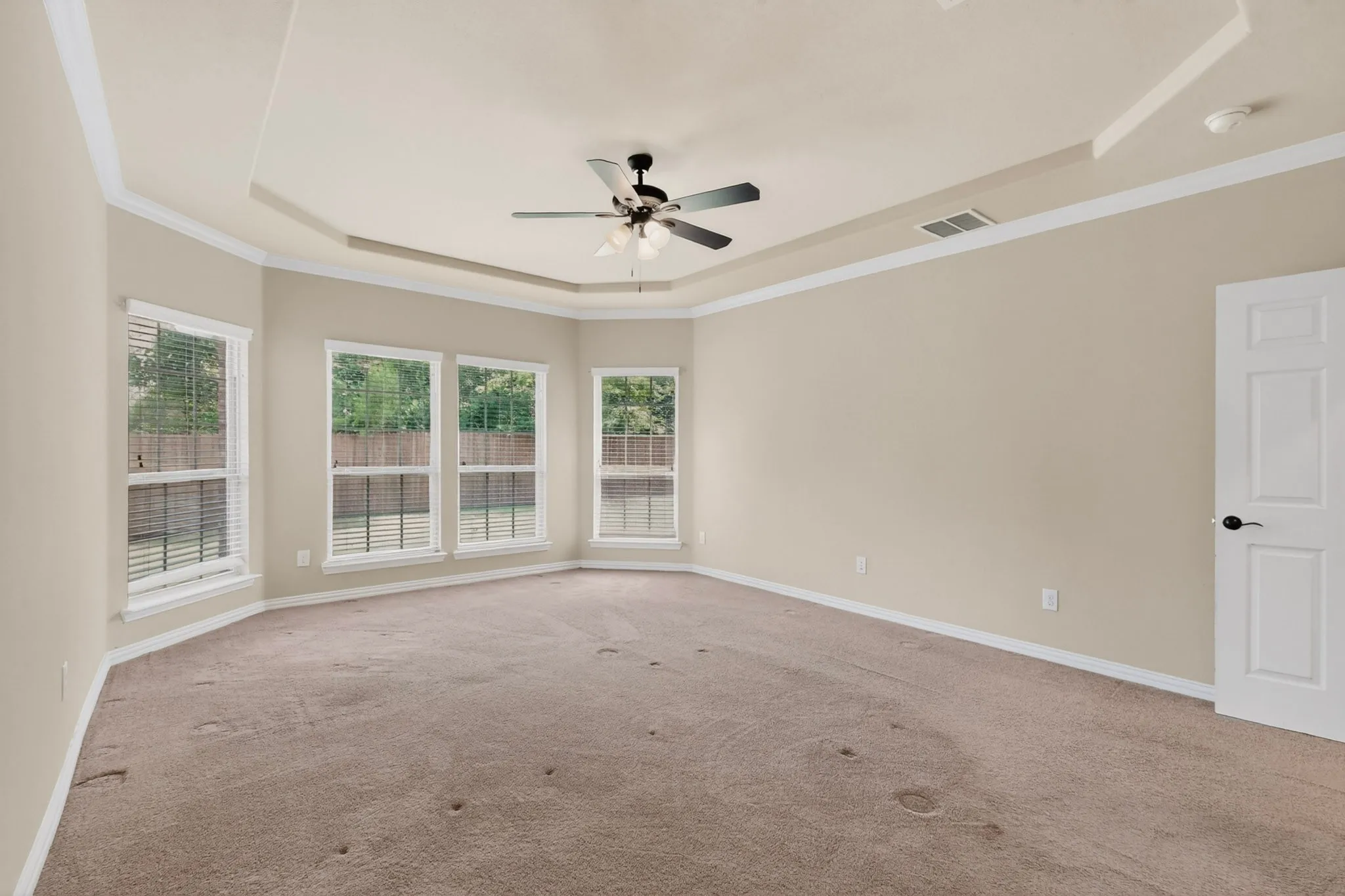 ANOTHER VIEW OF THE LARGE MASTER BEDROOM WITH TREY CEILINGS AND A VIEW OF THE BACK YARD...