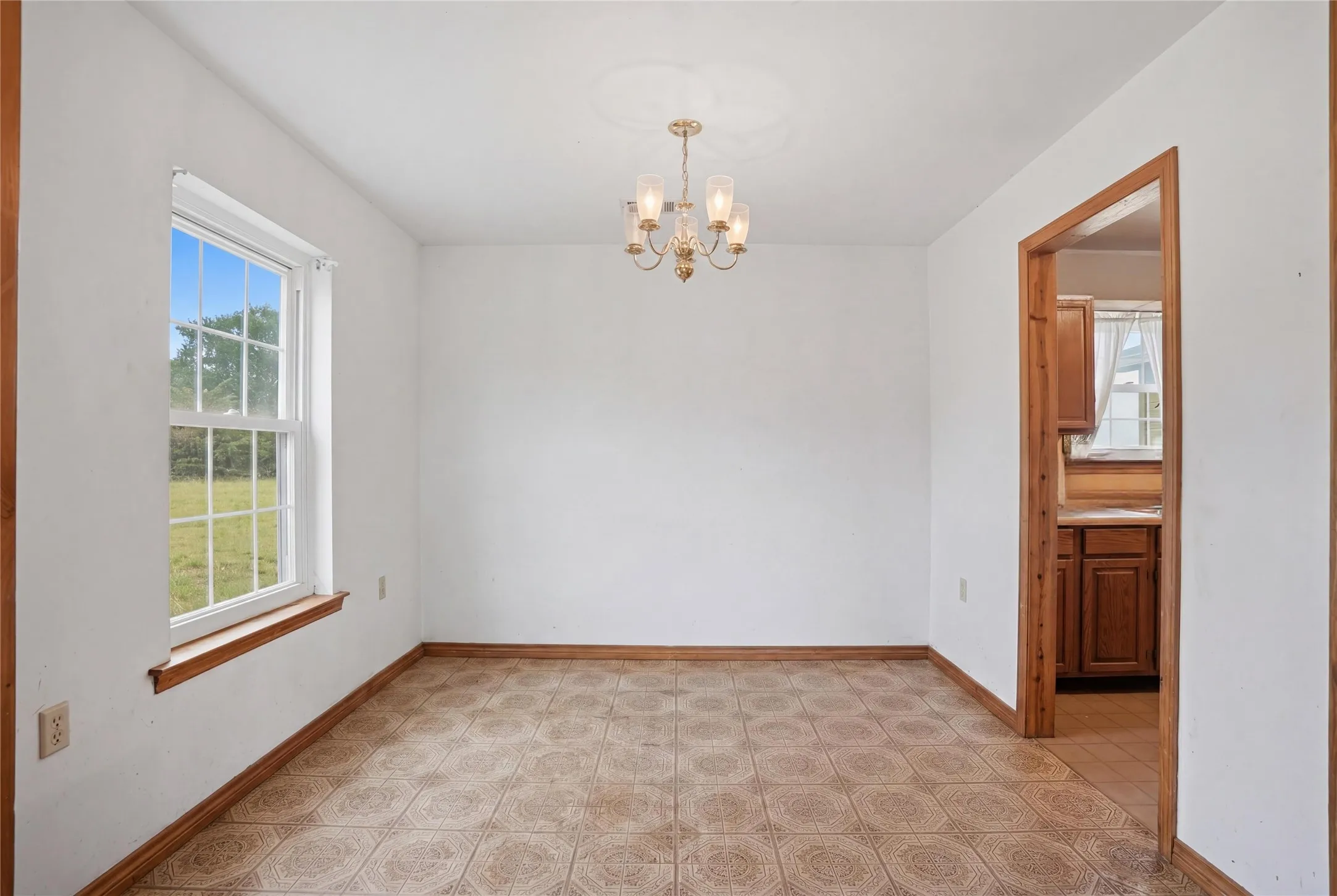 Functional dining room featuring neutral tones and an open flow into the adjacent kitchen