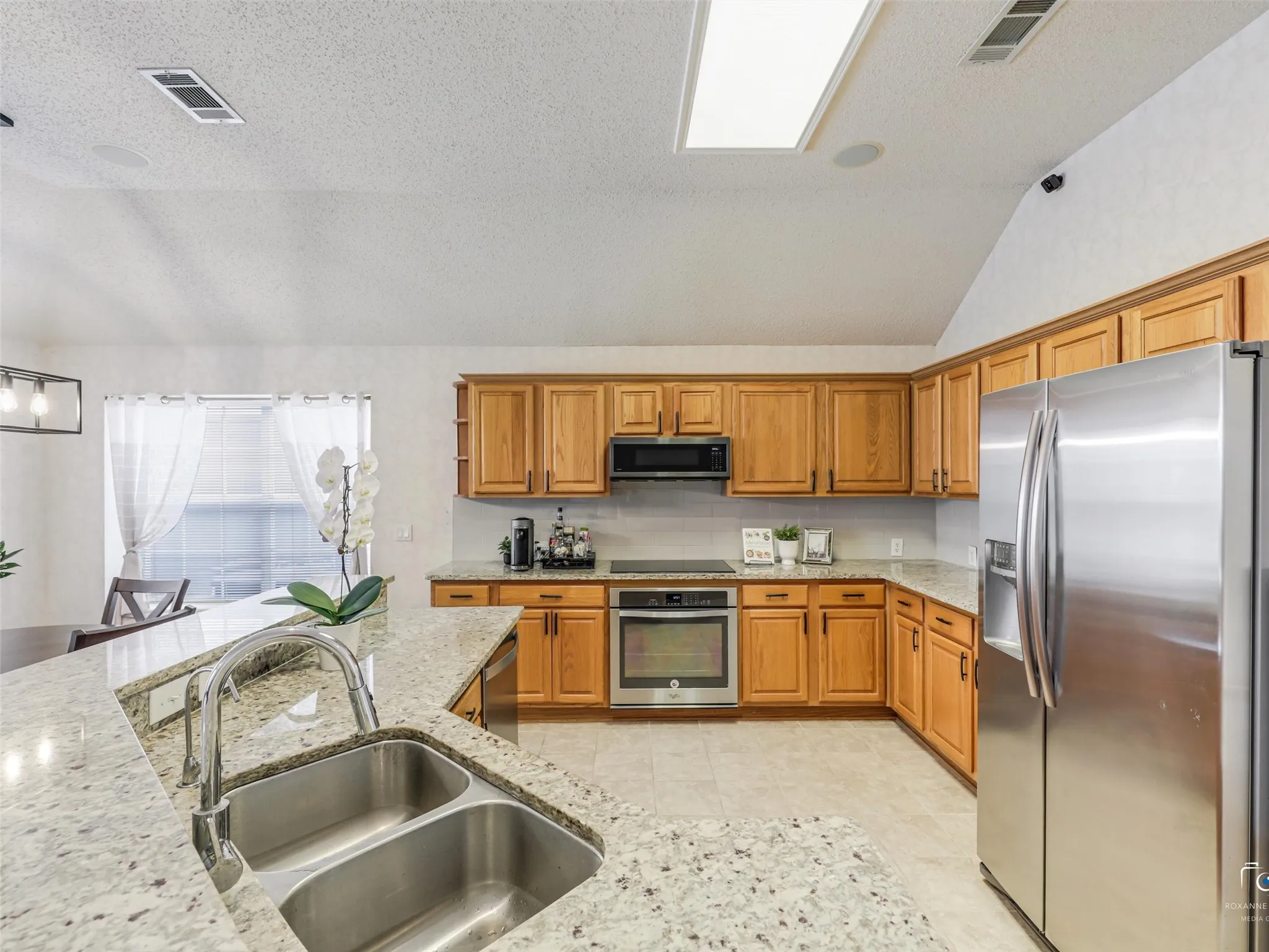 Open Kitchen with lots of storage space, countertops, and upgraded appliances.