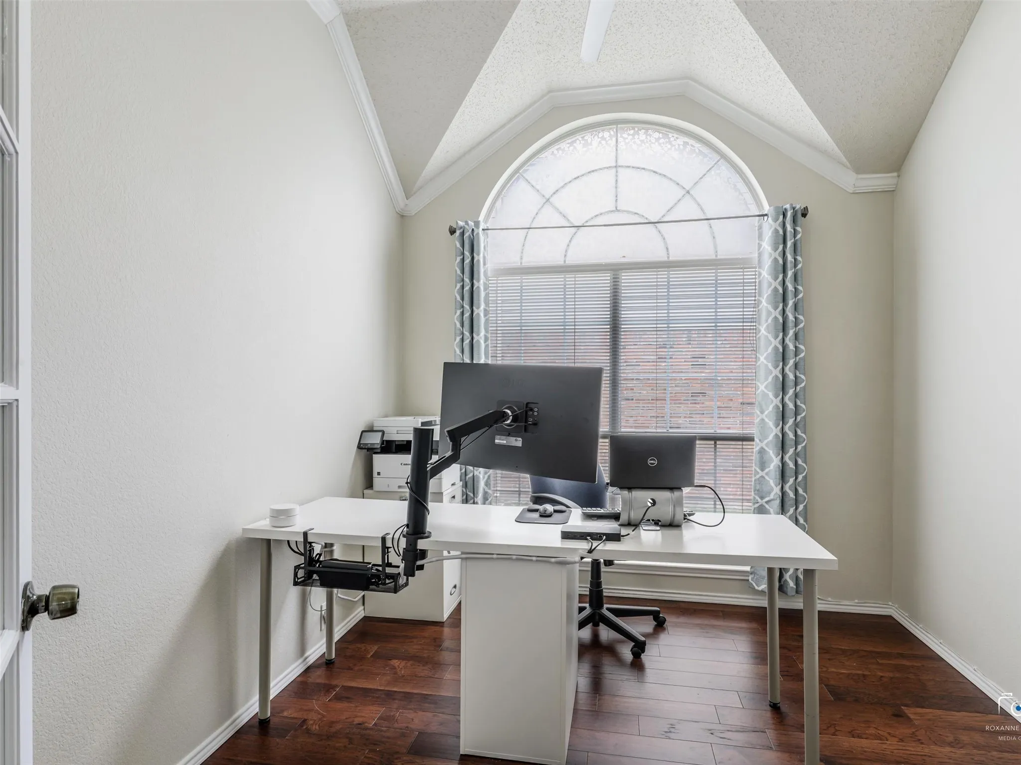 Designated office space offering French doors for privacy, high window for lots of natural light, and vaulted ceilings.