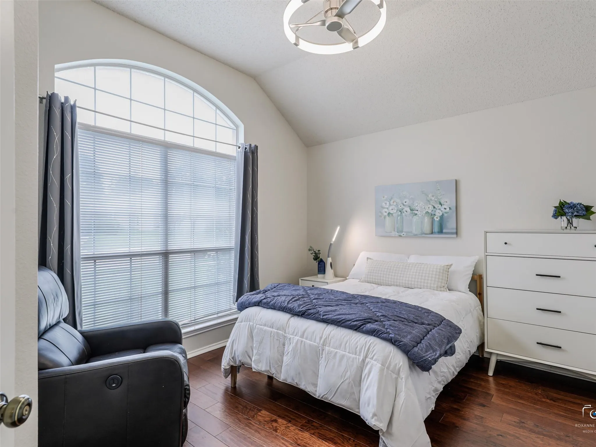 Secondary bedrooms offer lots of natural light, updated fixtures, high ceilings and warm wood flooring.