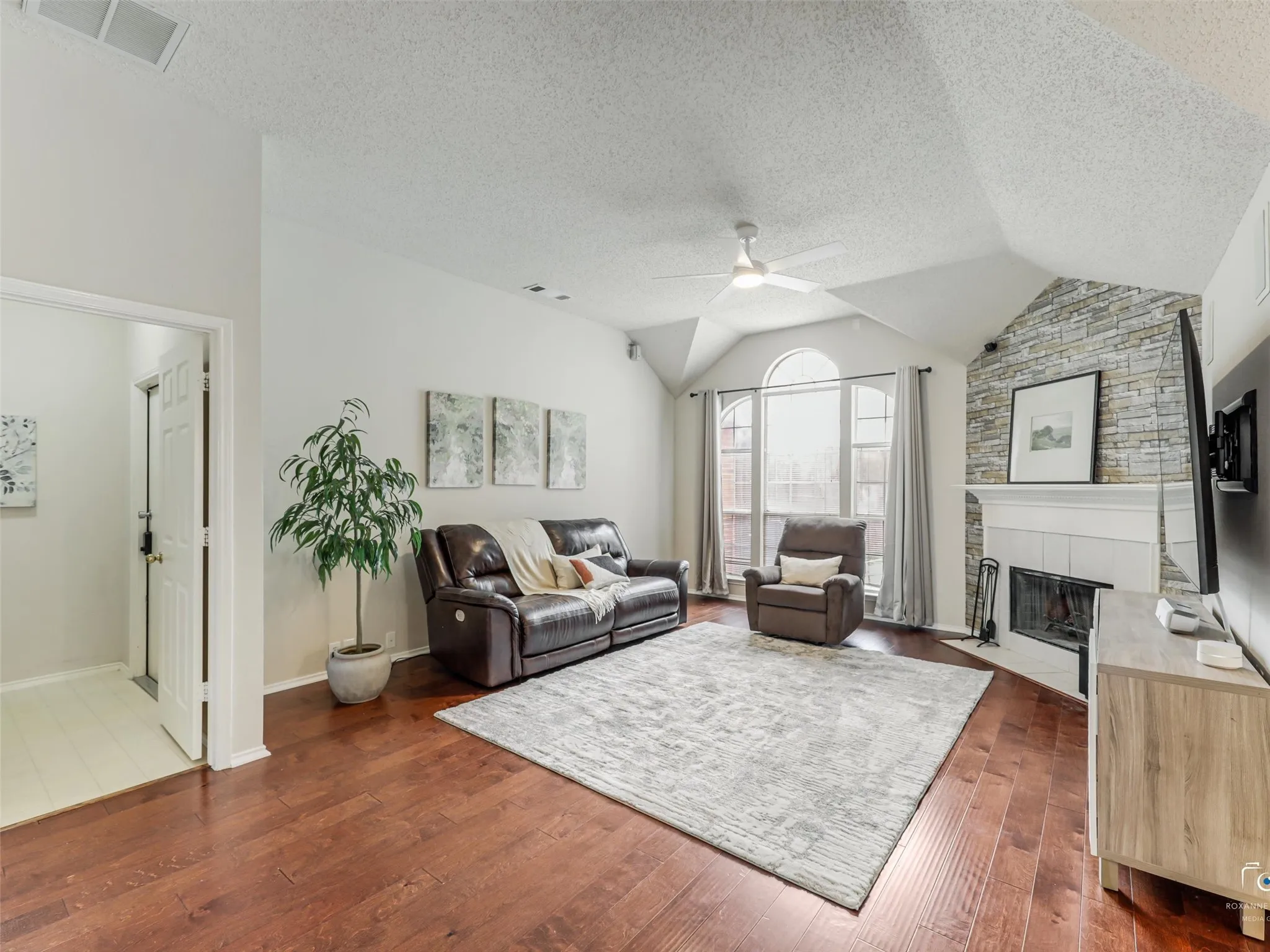 Nice sized living area with vaulted ceilings and lots of natural light.  Warm wood flooring and cozy fireplace.