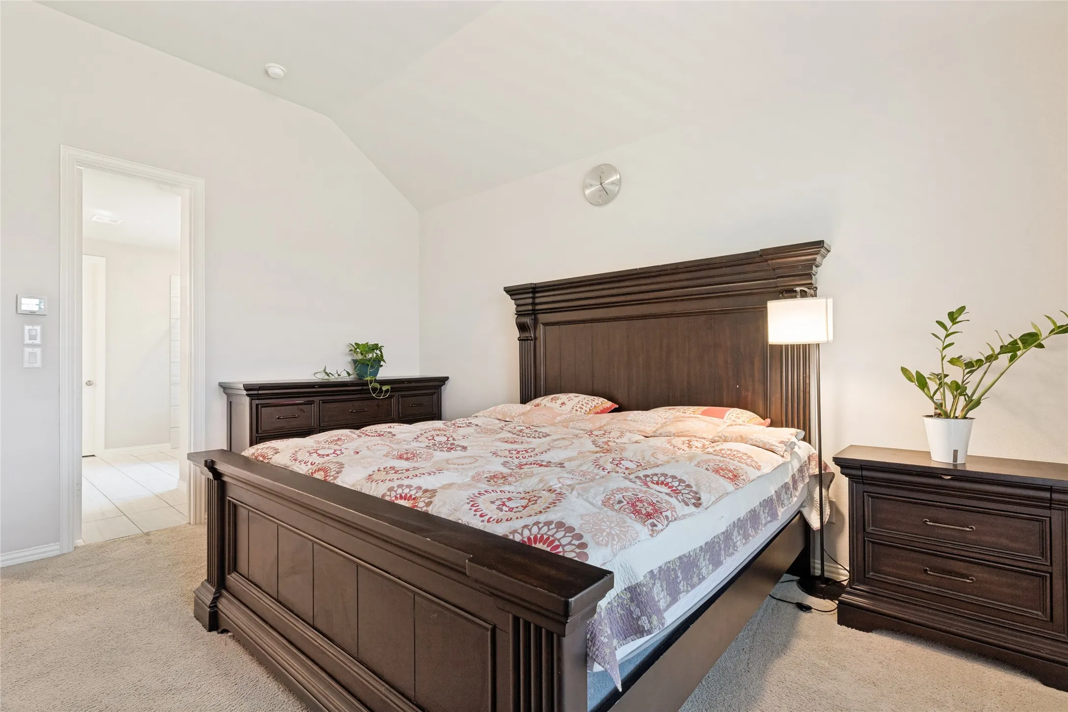 Bedroom featuring vaulted ceiling, recessed lighting, and soft carpet flooring