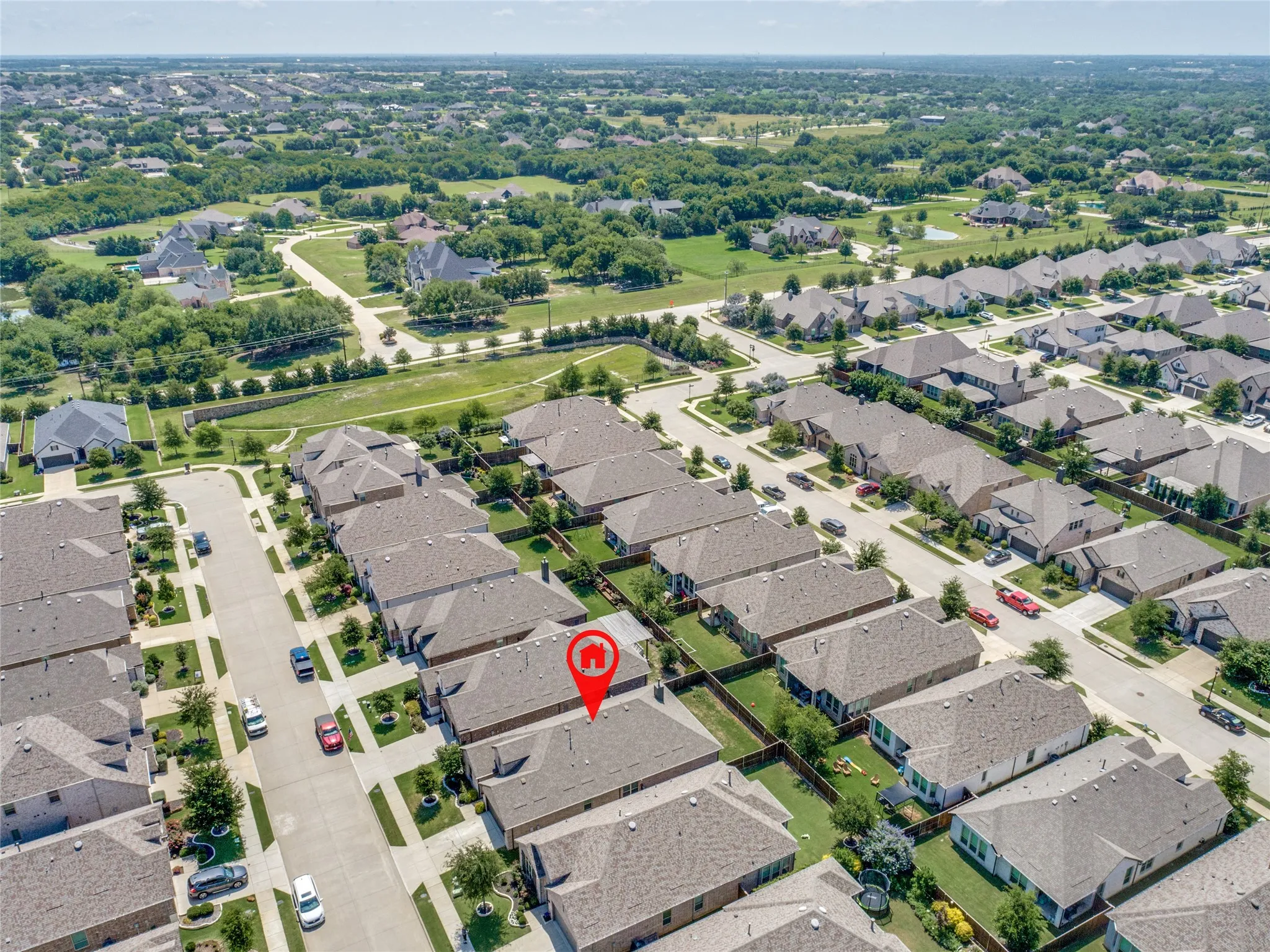 Aerial perspective of a residential neighborhood with uniformly designed homes featuring shingle roofs