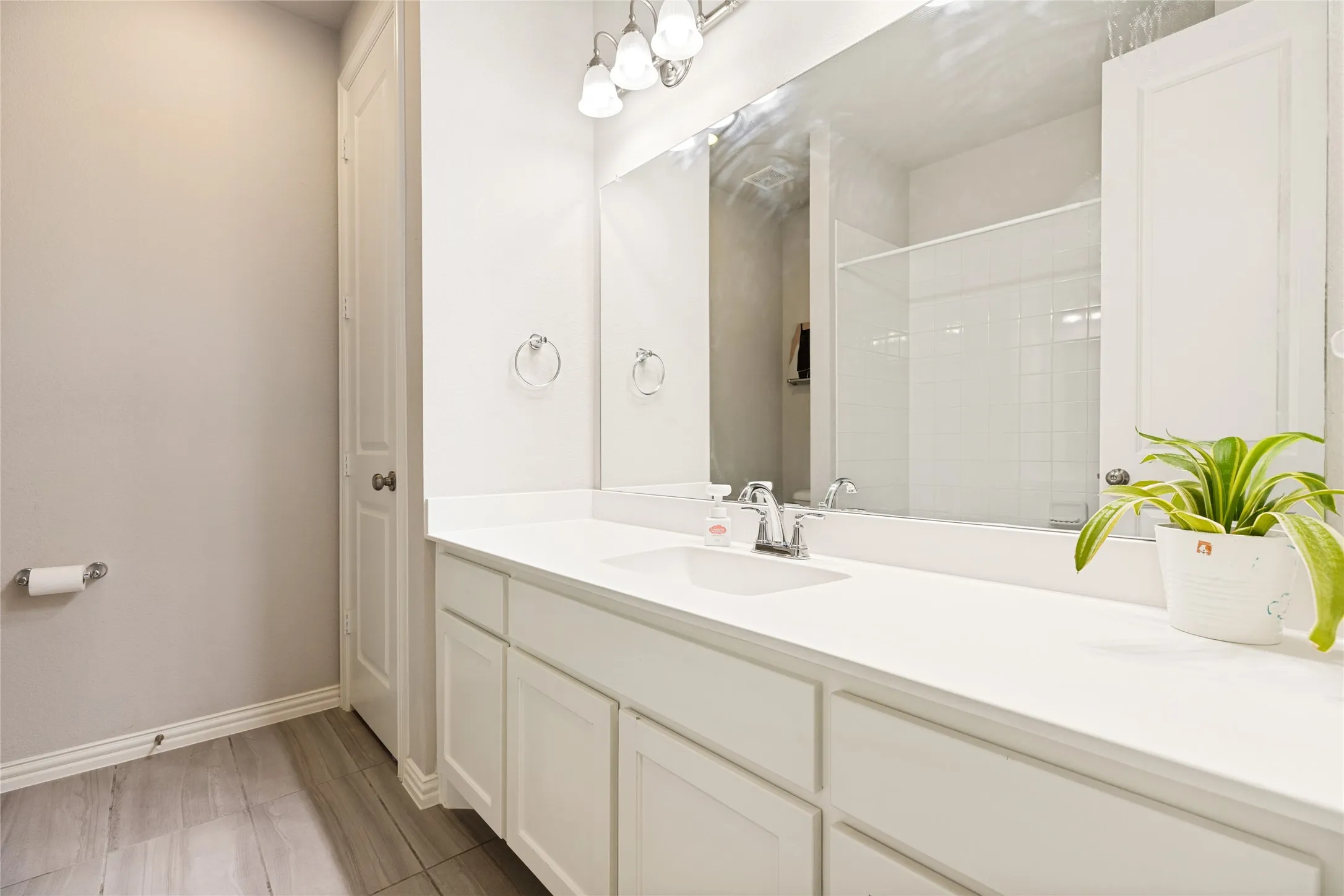 White vanity with an integrated sink and ample counter space
