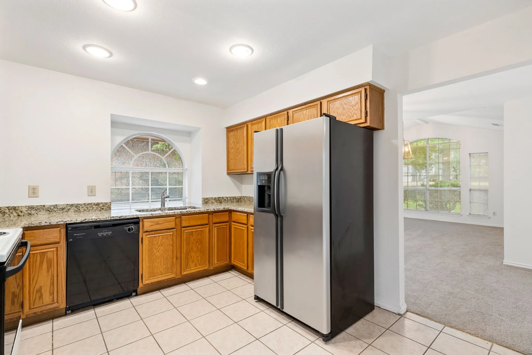 Kitchen open to living room. Granite counter tops and under mount sink.