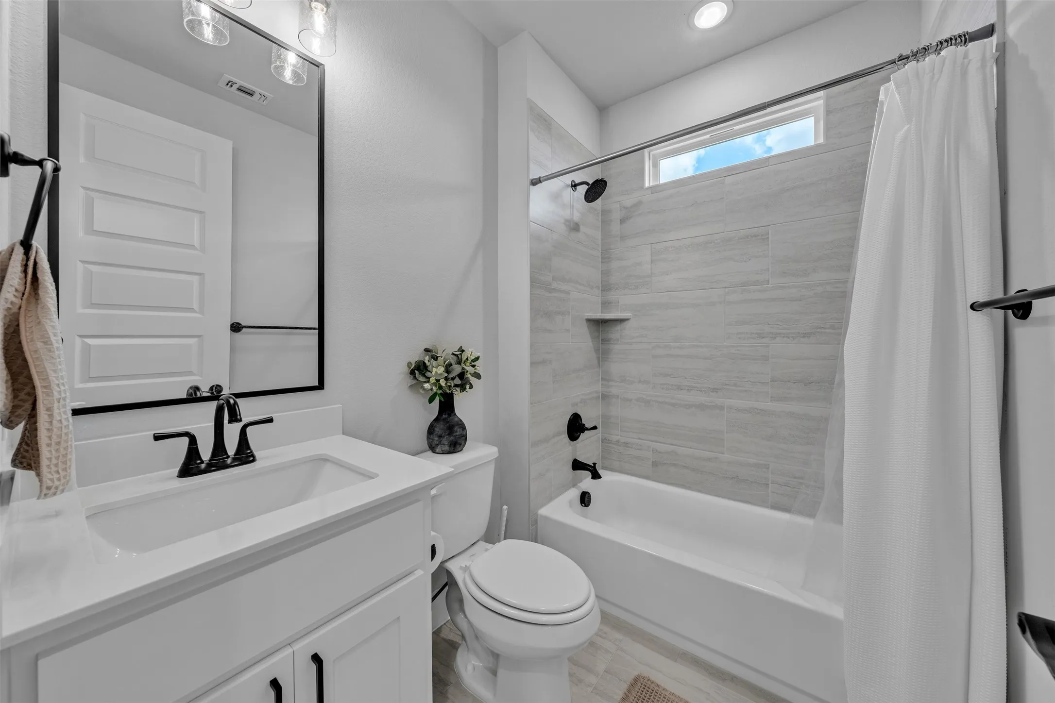 Dedicated utility area featuring wood-finish flooring, a window with blinds, built-in shelving, and a built-in countertop