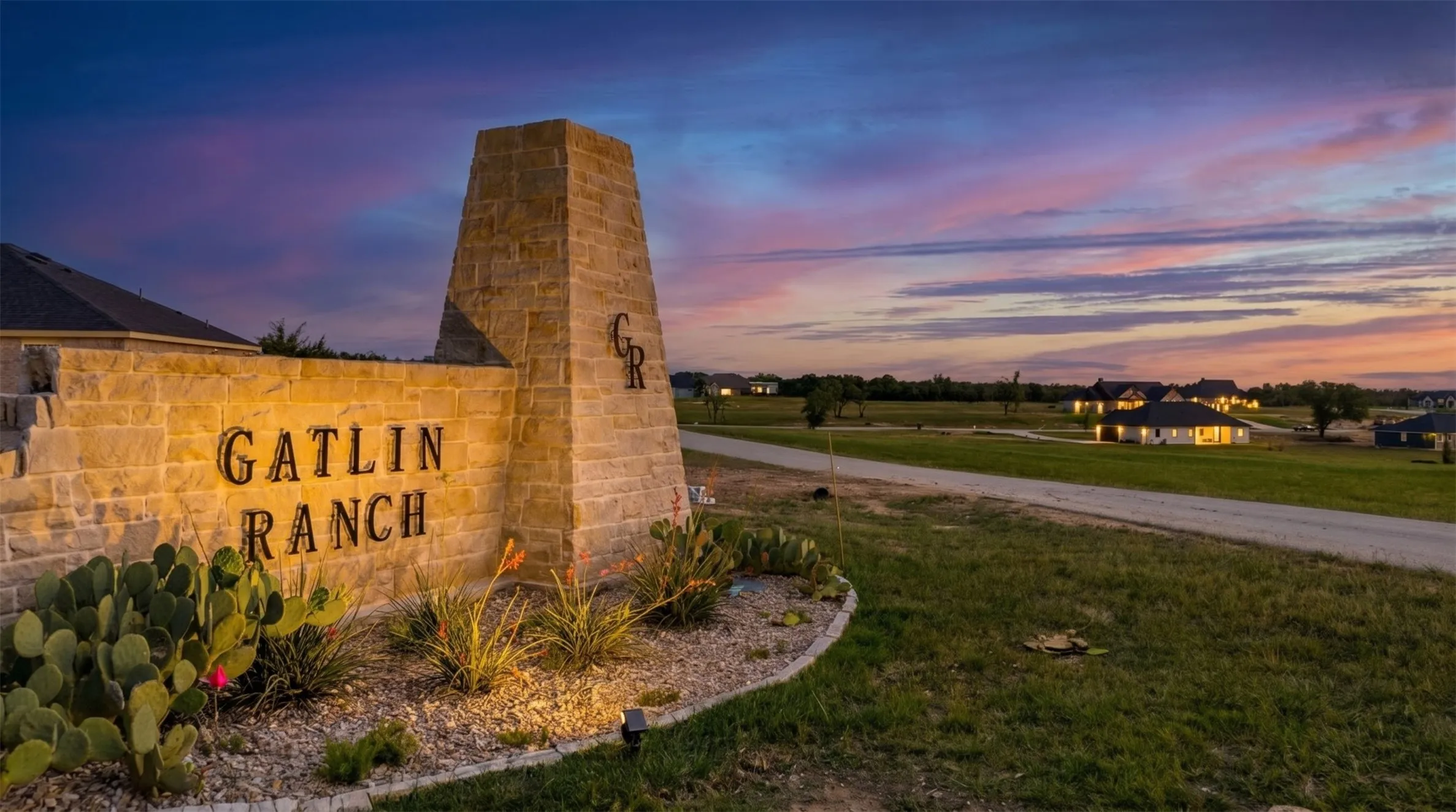 Stone entry monument featuring "Gatlin Ranch" lettering and integrated lighting