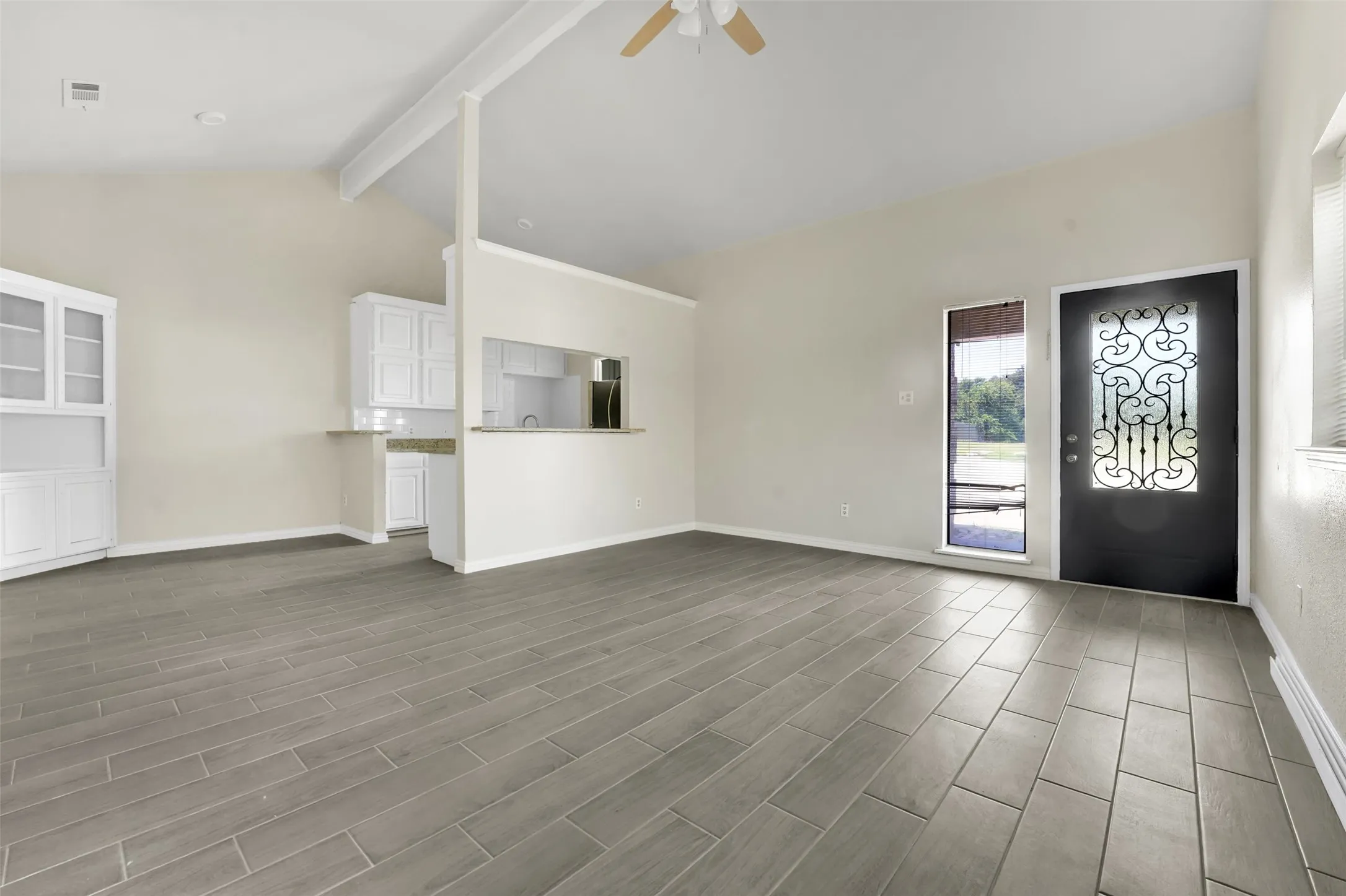 Unfurnished living room with ceiling fan and dark wood finished floors