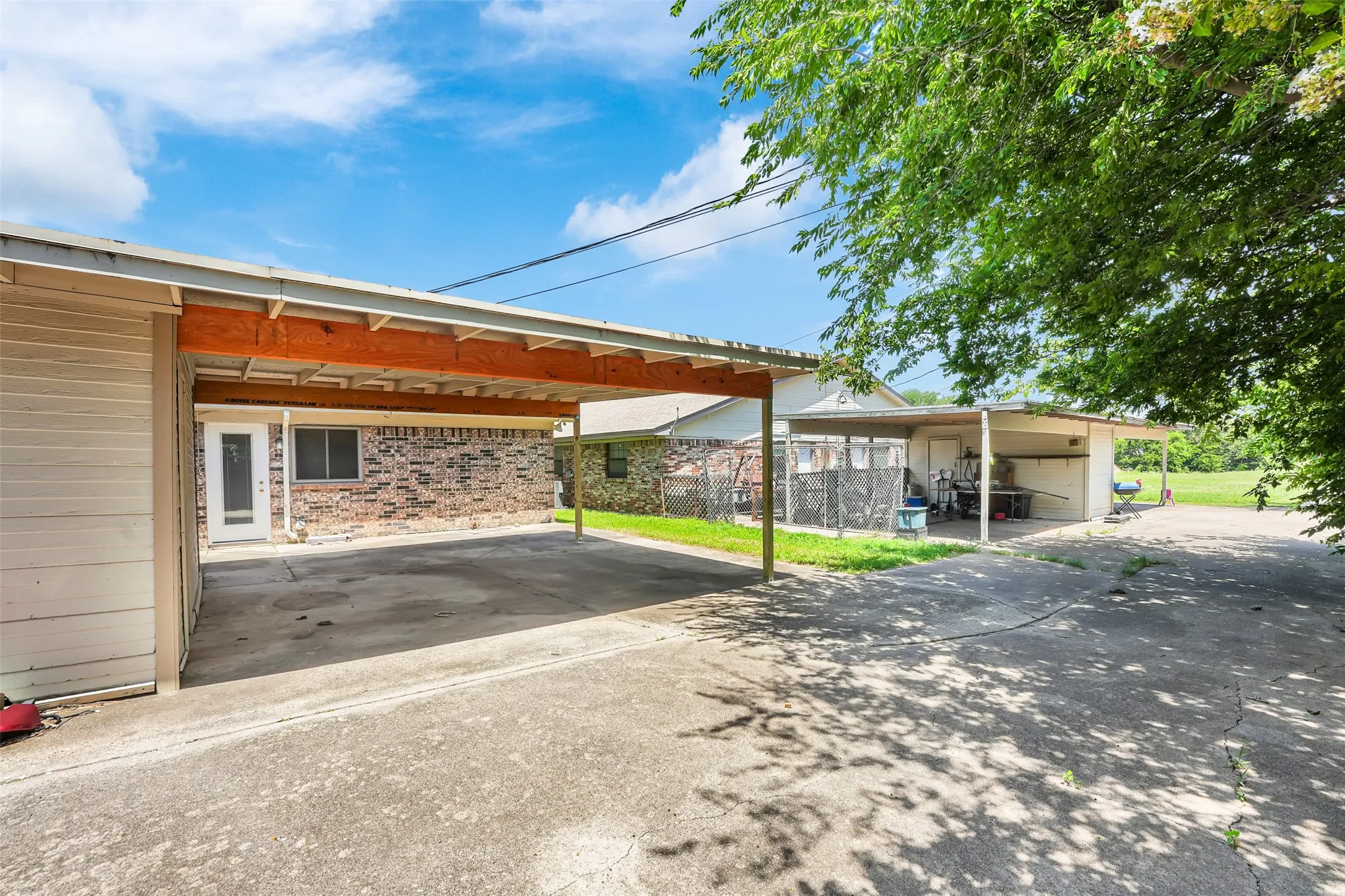 View of car parking with a carport and concrete driveway