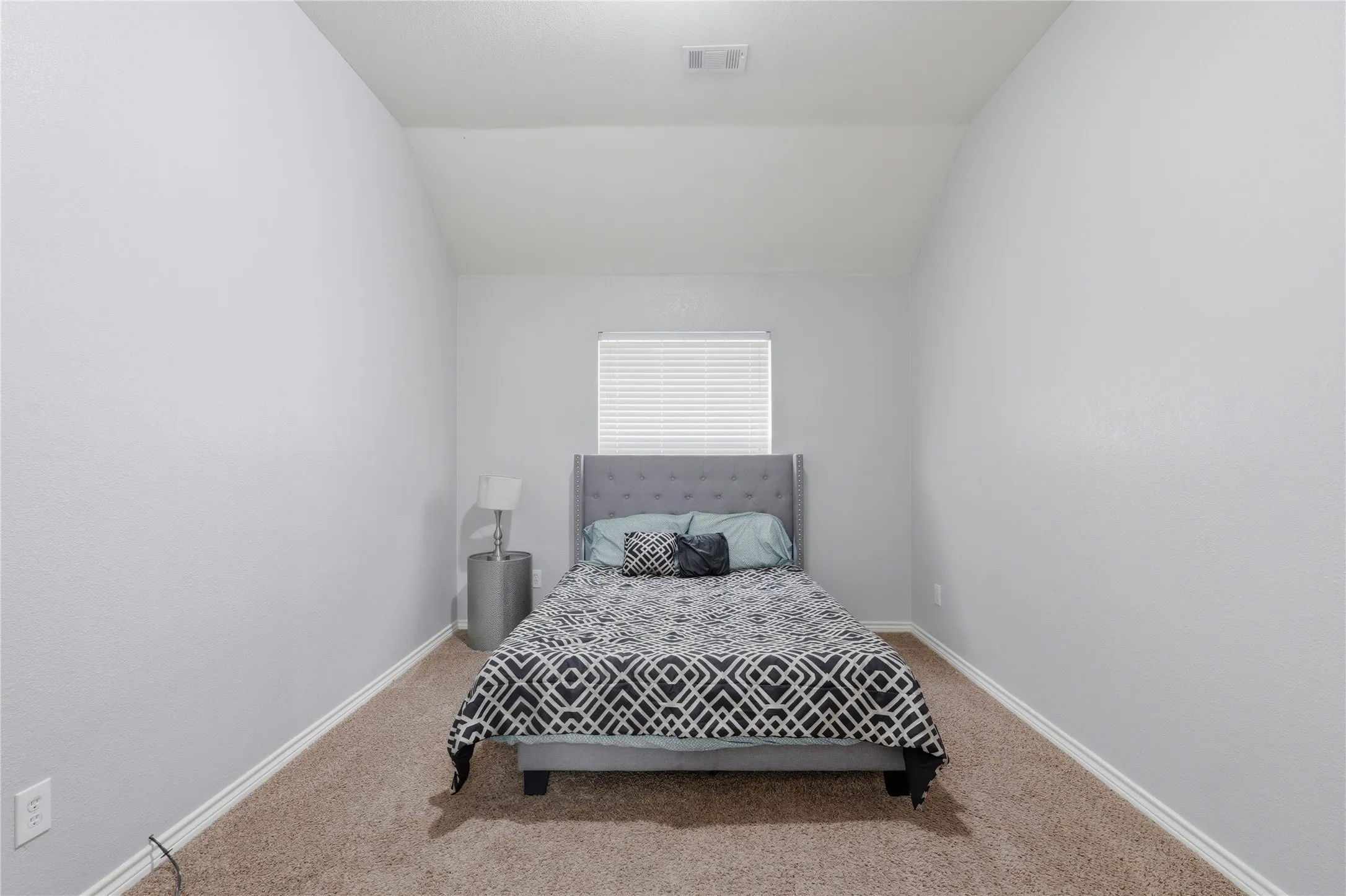 Carpeted room with light gray walls and white trim