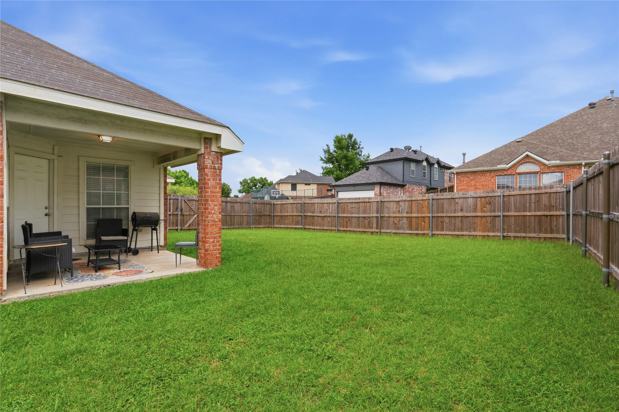 Expansive grass yard featuring a wood fence perimeter