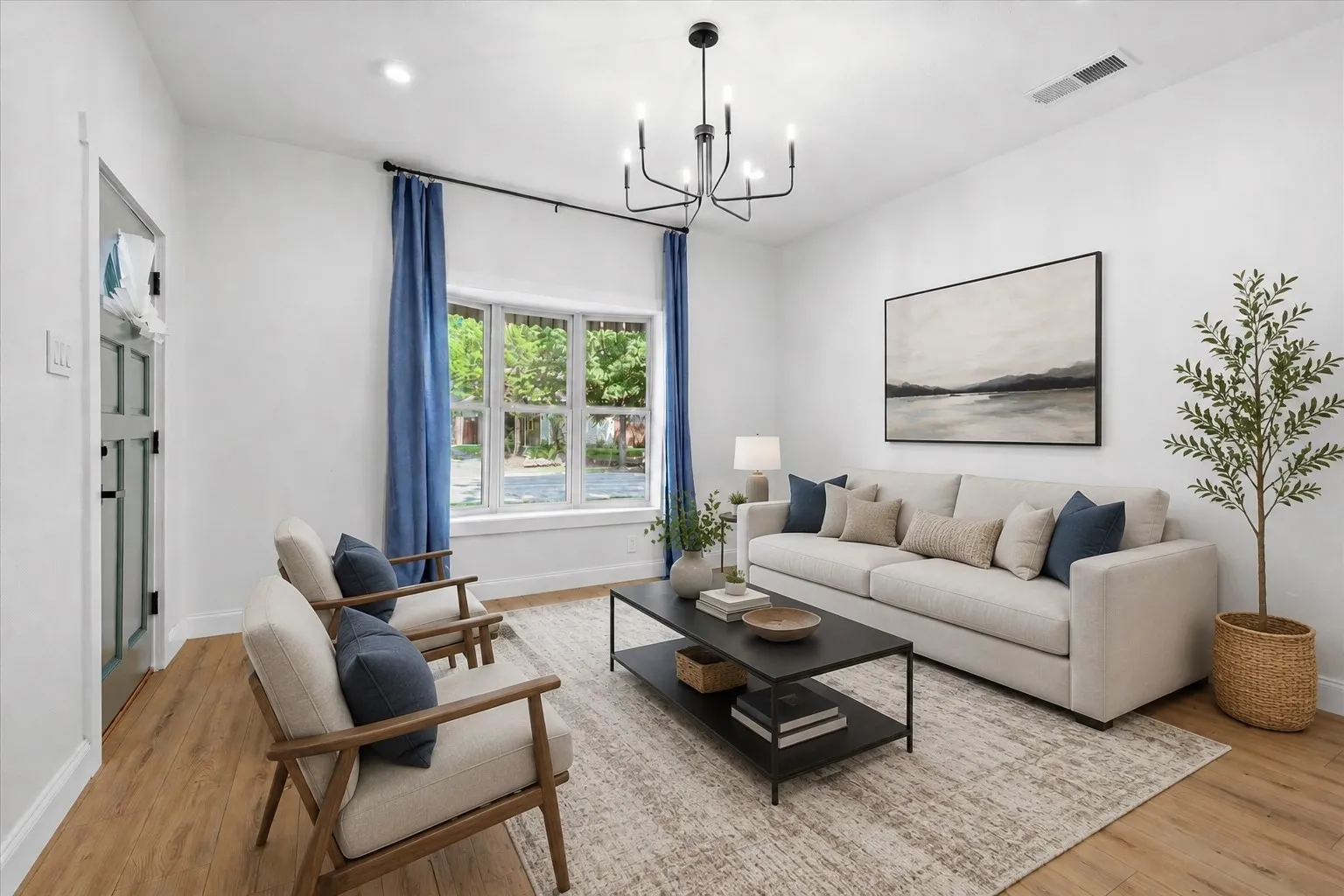 Bright living space featuring wood-finish flooring, a bay window, recessed lighting, and a contemporary chandelier