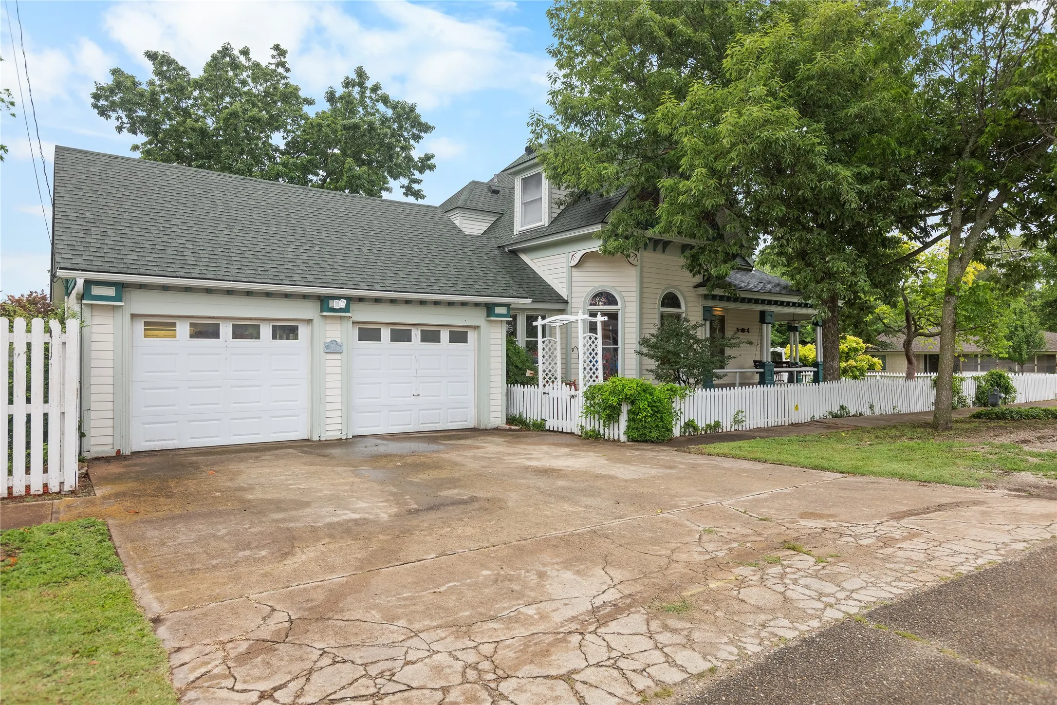 Two-car garage with white paneled doors and upper window inserts