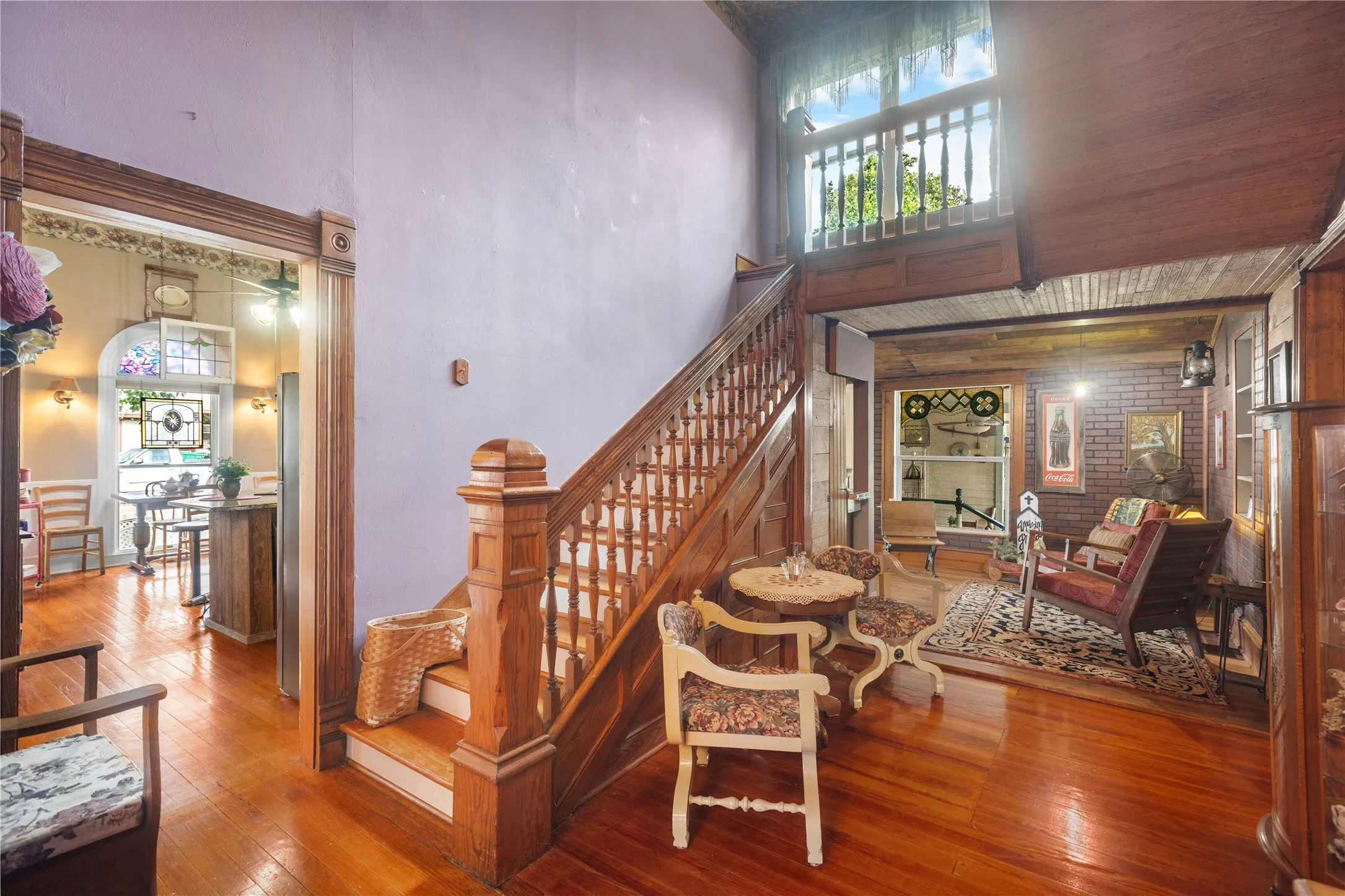 Rich wood-finish flooring throughout, complemented by a substantial wooden staircase and balustrade