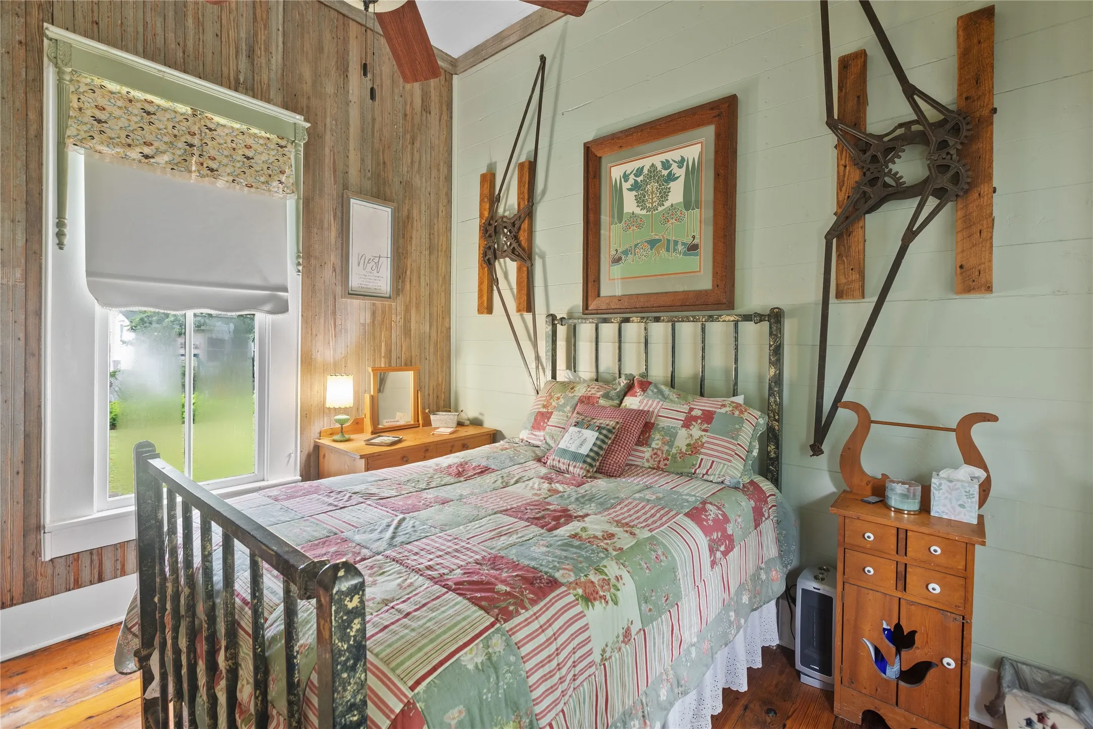 The Nest (dwelling 3)Bedroom featuring vertical wood-finish wall paneling and a large window