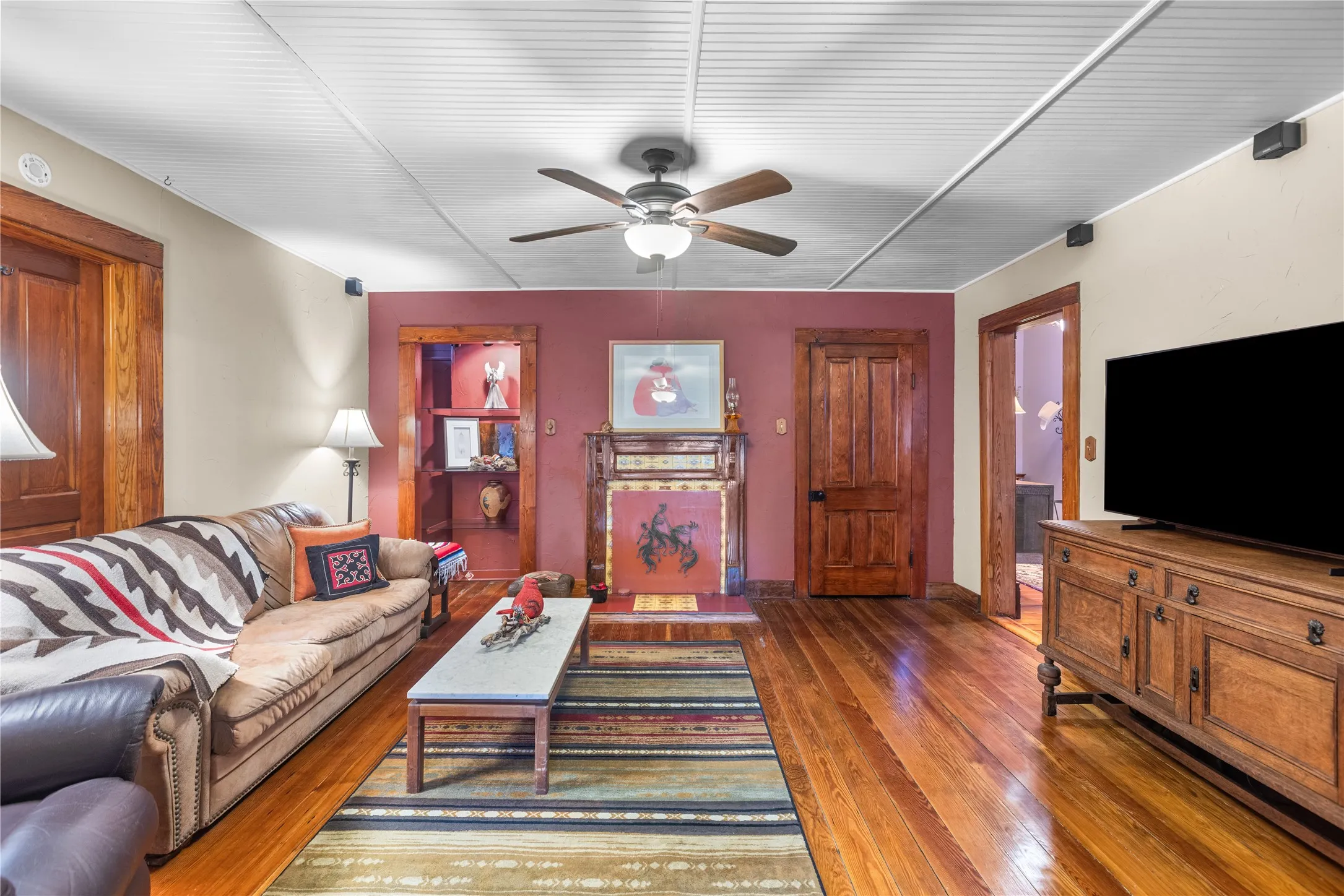 Living area featuring wood-finish flooring, a decorative fireplace, and a built-in display niche