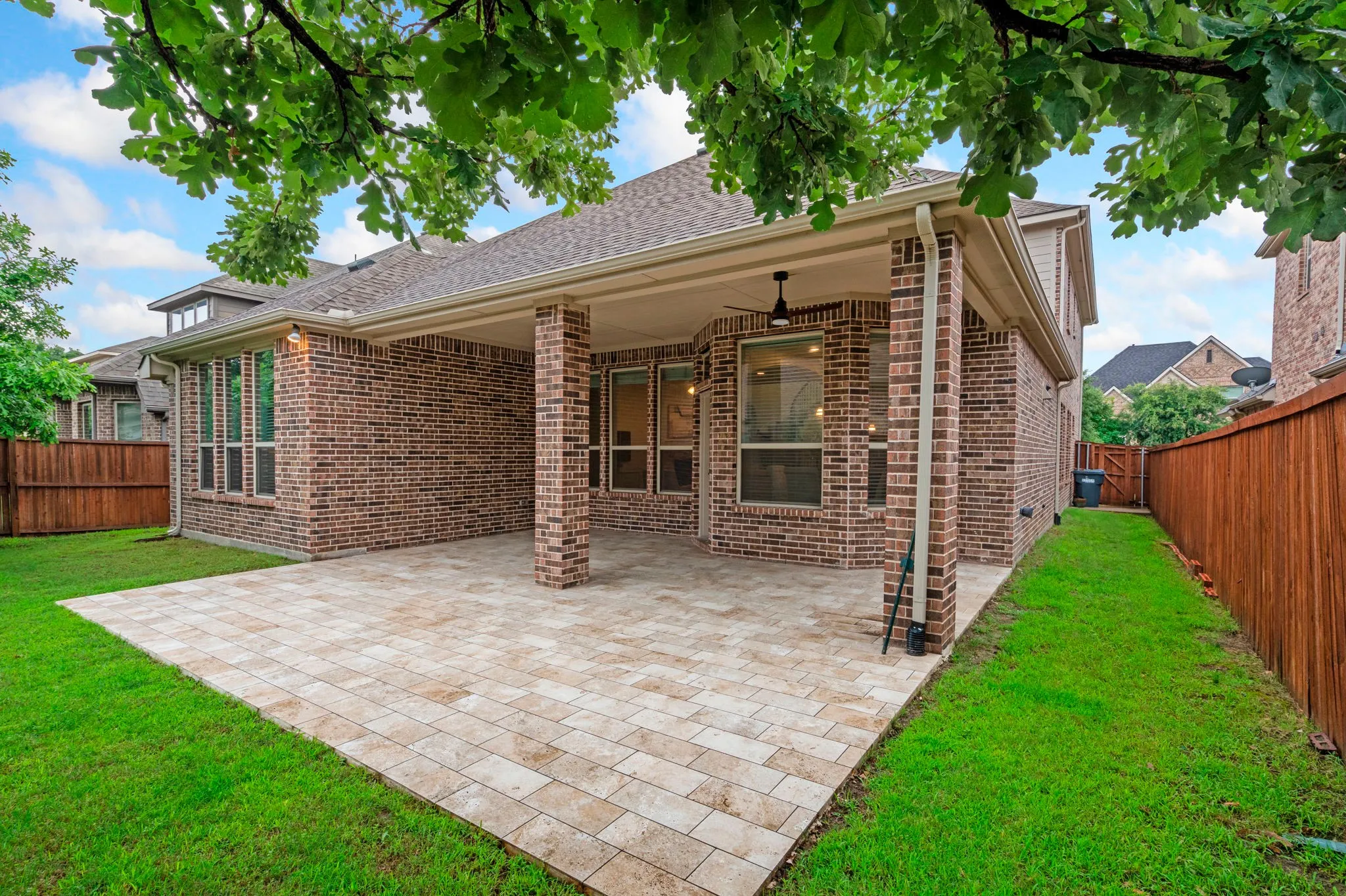 This large covered back patio with a ceiling fan creates the perfect outdoor living space for year-round enjoyment, offering a comfortable retreat for morning coffee, weekend BBQs, and relaxed evenings with family and friends.