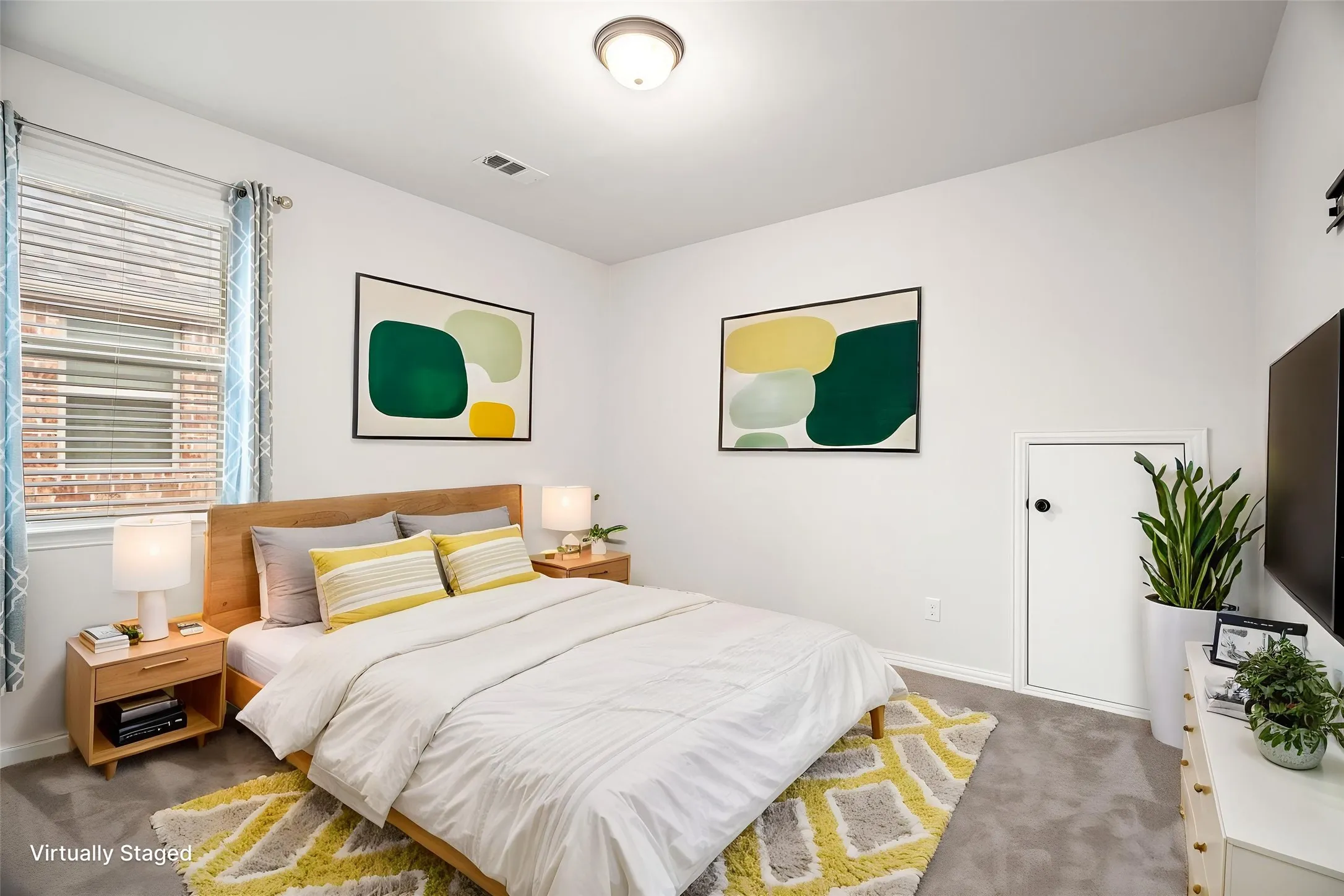 Another upstairs bedroom features virtual staging, helping to envision the space as a warm and functional retreat for guests, family, or everyday living.