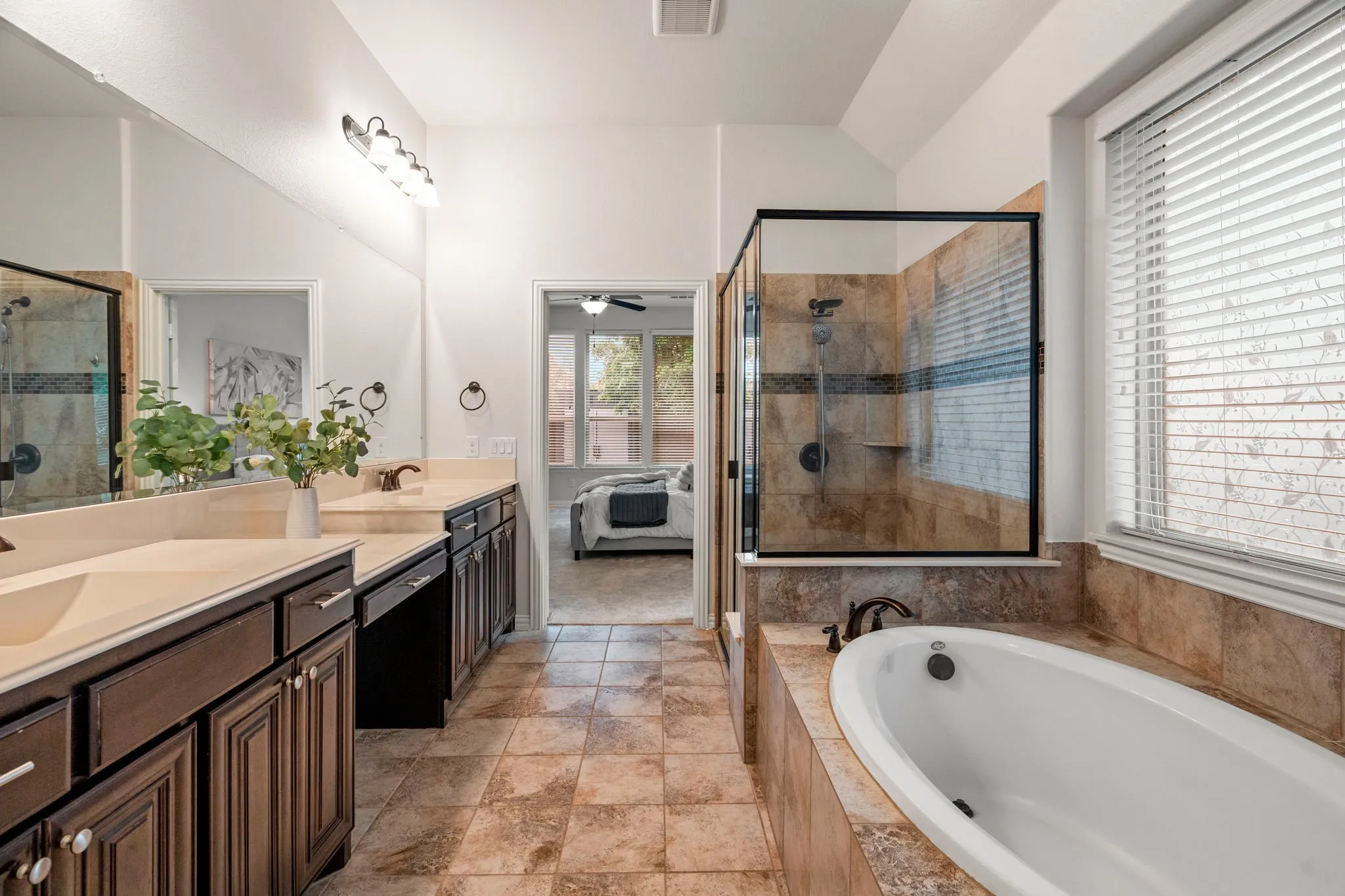 The primary bath offers both a deep soaking tub and a separate shower, delivering a thoughtfully designed space that supports both relaxation and efficiency.