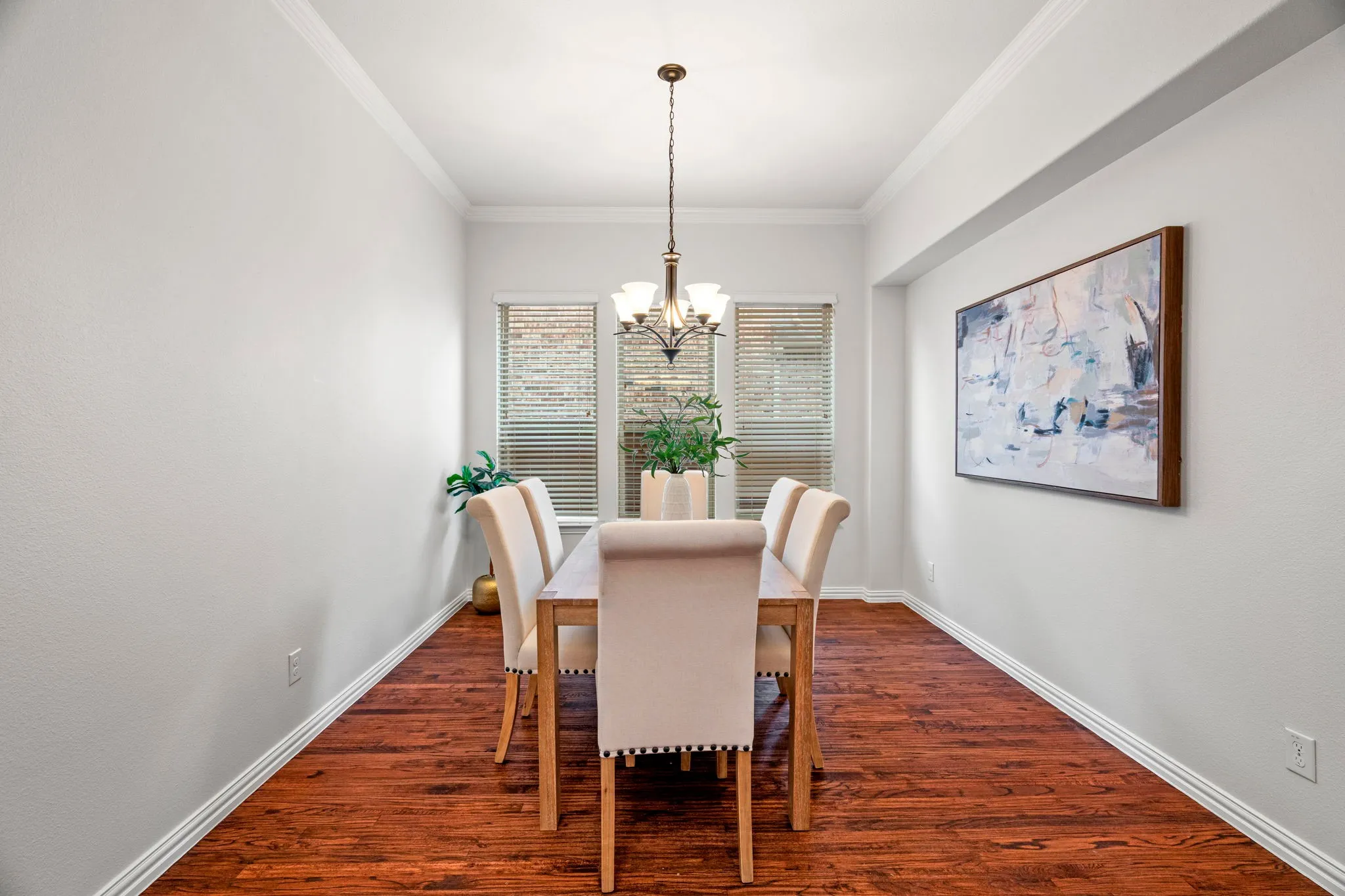 The dining room showcases beautiful hardwood floors, creating a warm and inviting space perfect for everyday meals, holiday gatherings, and effortless entertaining.