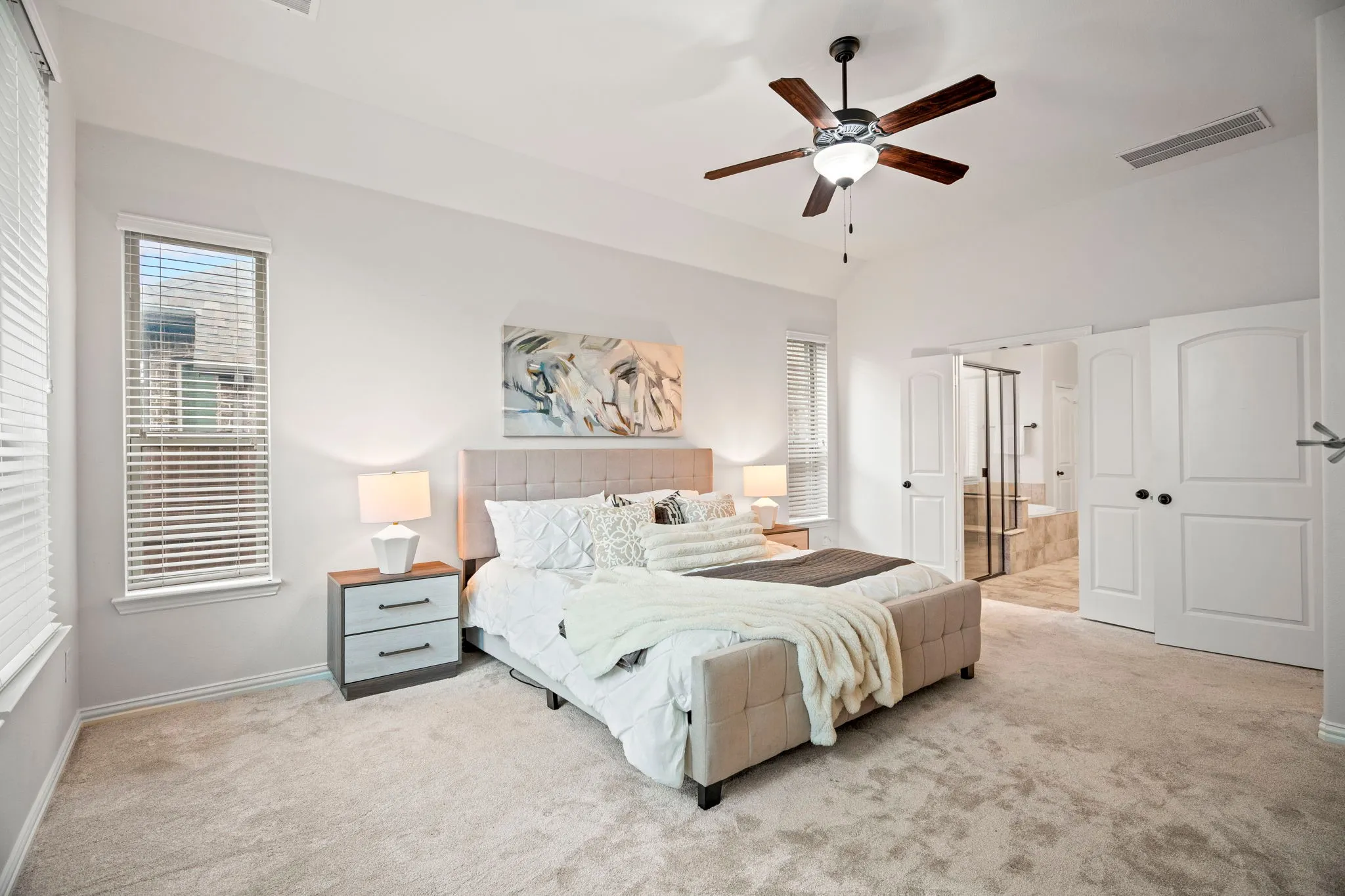 The primary suite is generously sized and privately located at the rear of the home, creating a quiet retreat perfect for relaxation and comfort.