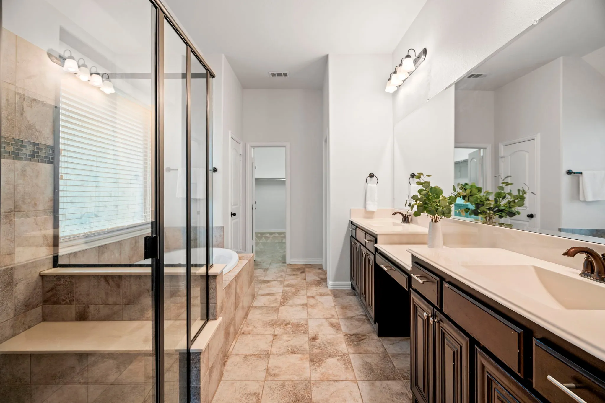 With dual vanities, a soaking tub, and a walk-in closet, the primary bath creates a comfortable and calming escape within the home.