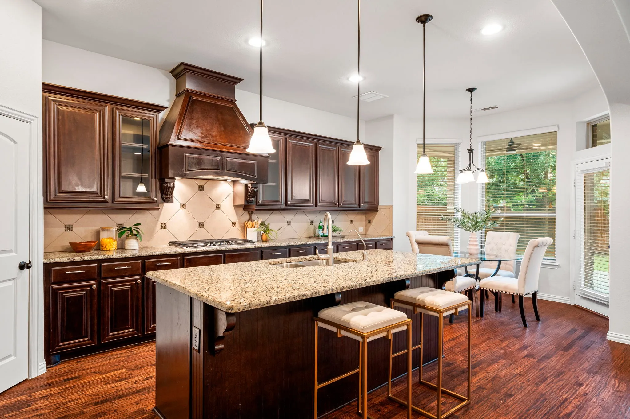 The open-concept kitchen serves as the heart of the home, featuring rich granite countertops and stainless steel appliances, seamlessly connecting to the main living spaces for effortless entertaining and everyday living.