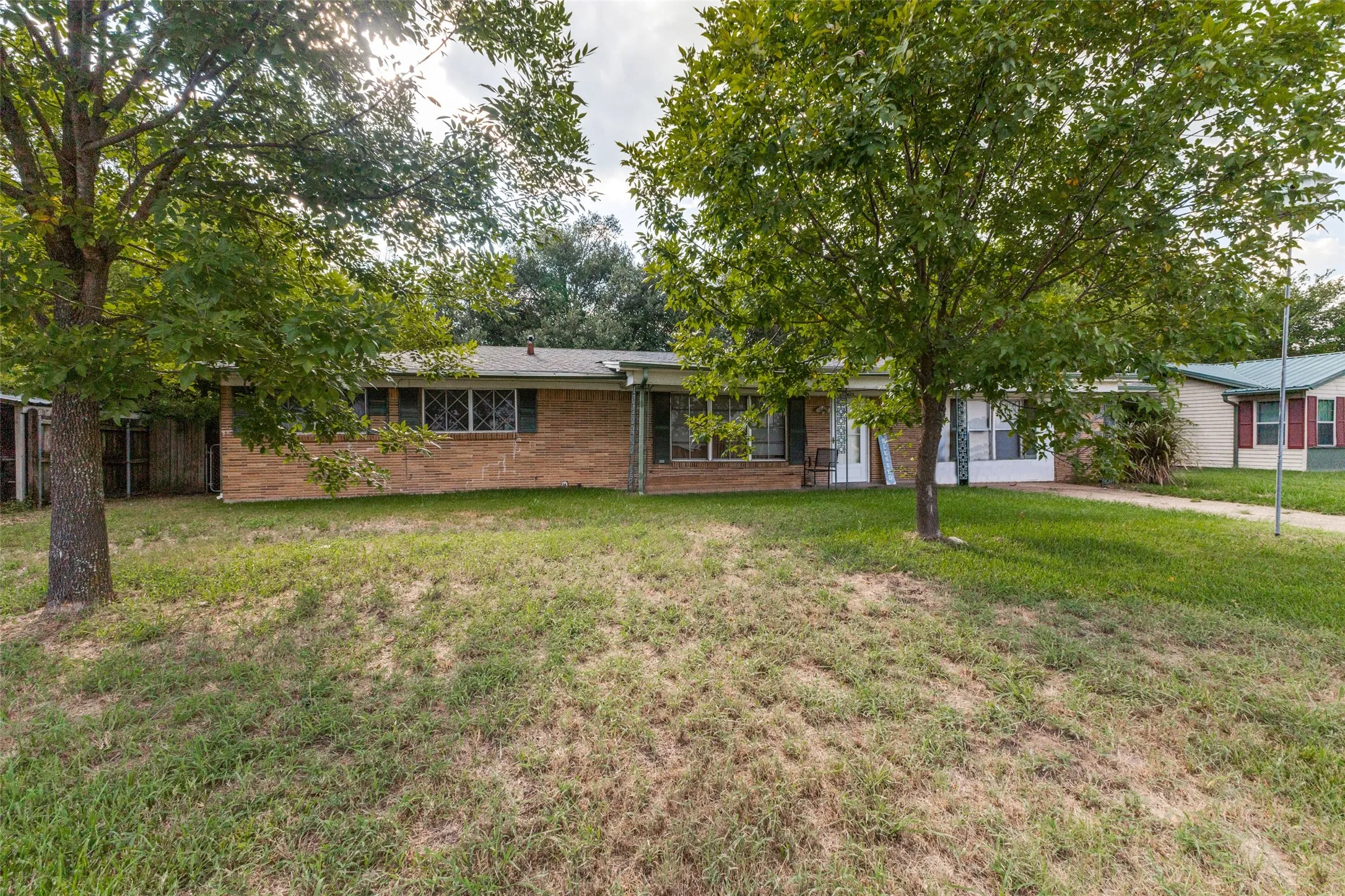 Ranch-style home featuring a front yard and brick siding