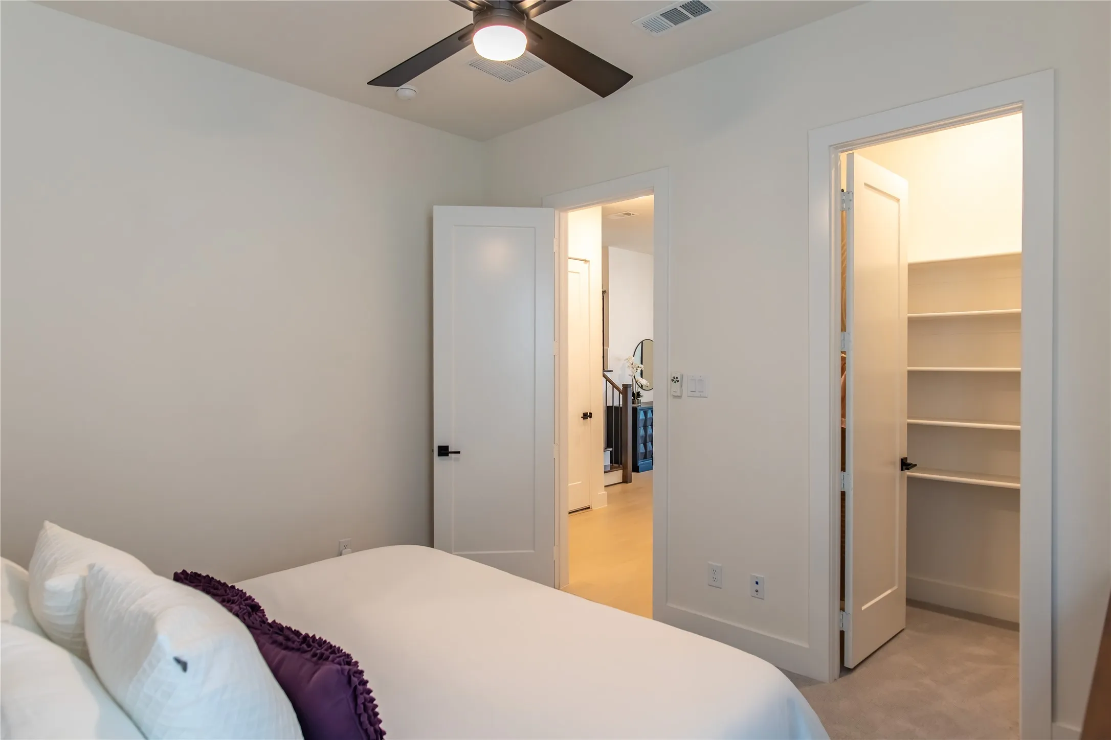 White interior walls featuring a ceiling fan with integrated lighting, recessed lighting, and a closet with built-in shelving