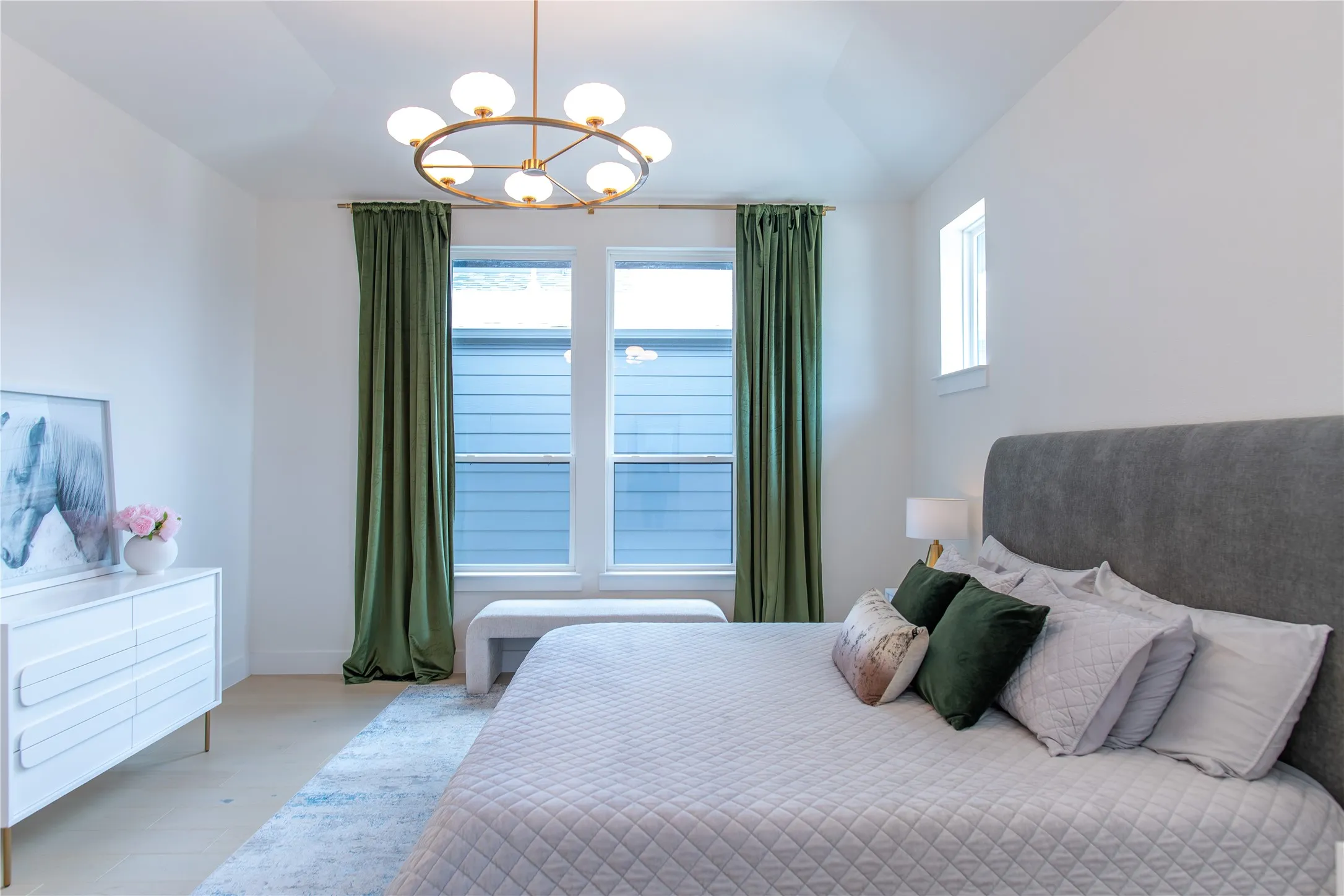 Vaulted ceiling featuring a contemporary brass chandelier