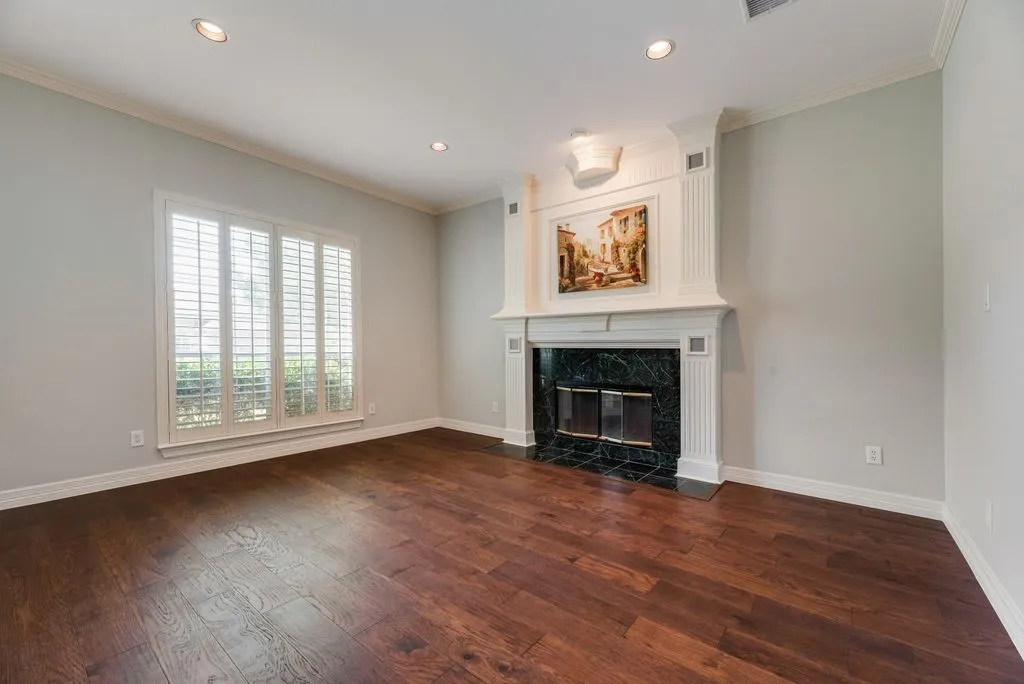 Formal living area featuring a fireplace with a white mantel and dark green stone surround
