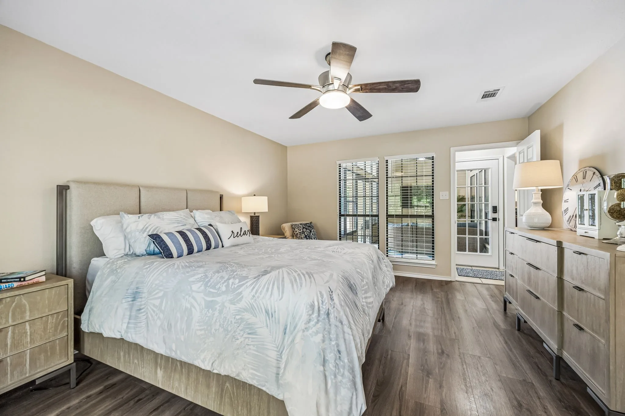 The primary bedroom also looks into the sunroom with easy access out to that peaceful spot.