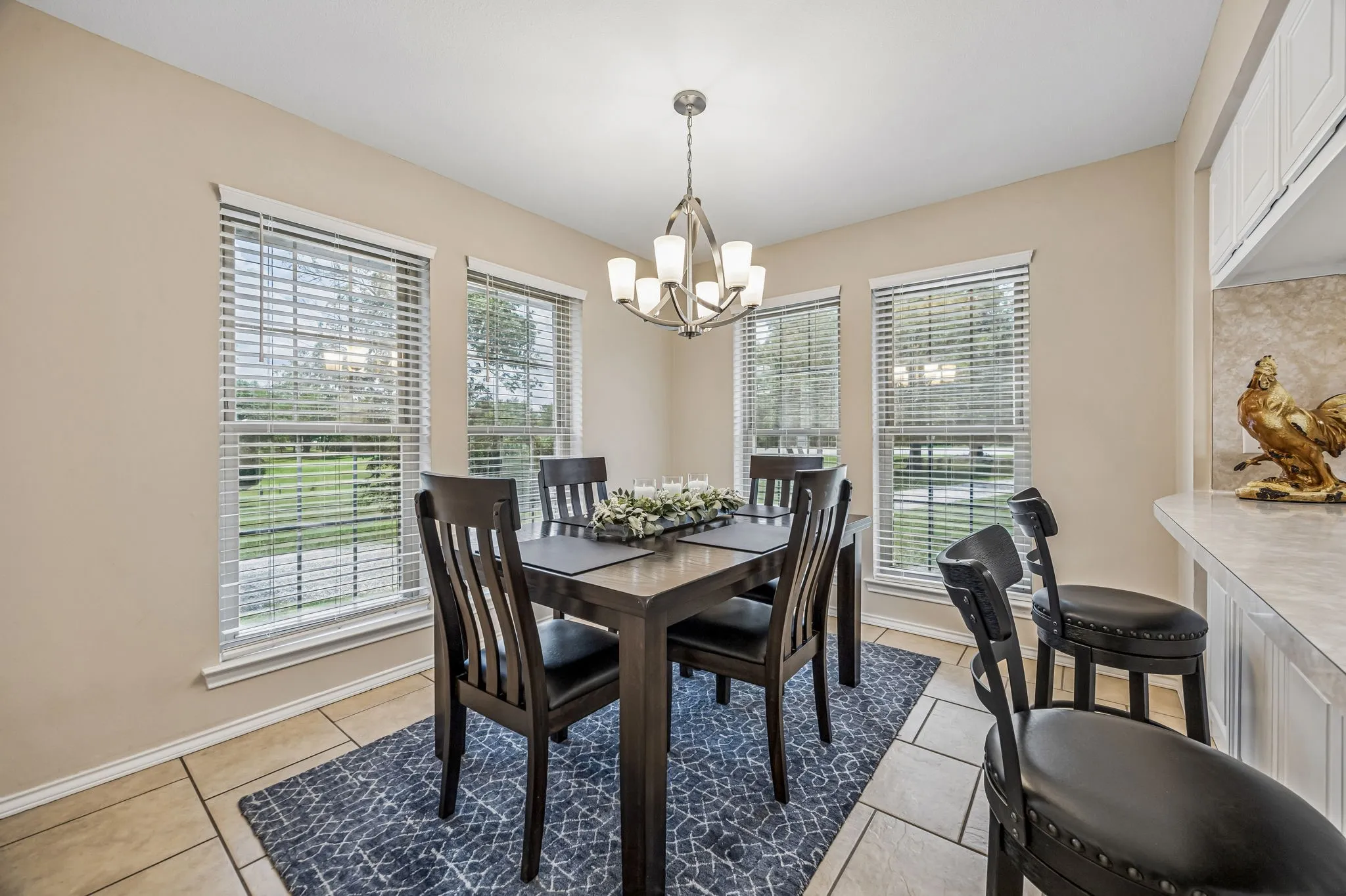 The breakfast area has a stylish updated light and is surrounded by windows providing wonderful light and beautiful views. The laundry room and pantry are off this space.