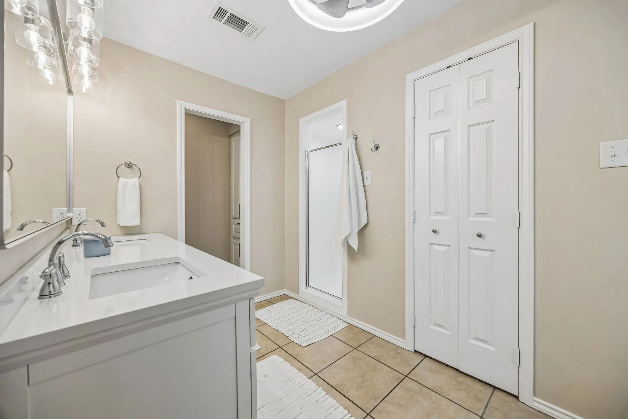 The separate show is a good size. The water closet is separate. The bath also has great storage with the linen closet in the background and walk in closet through the french doors shown.