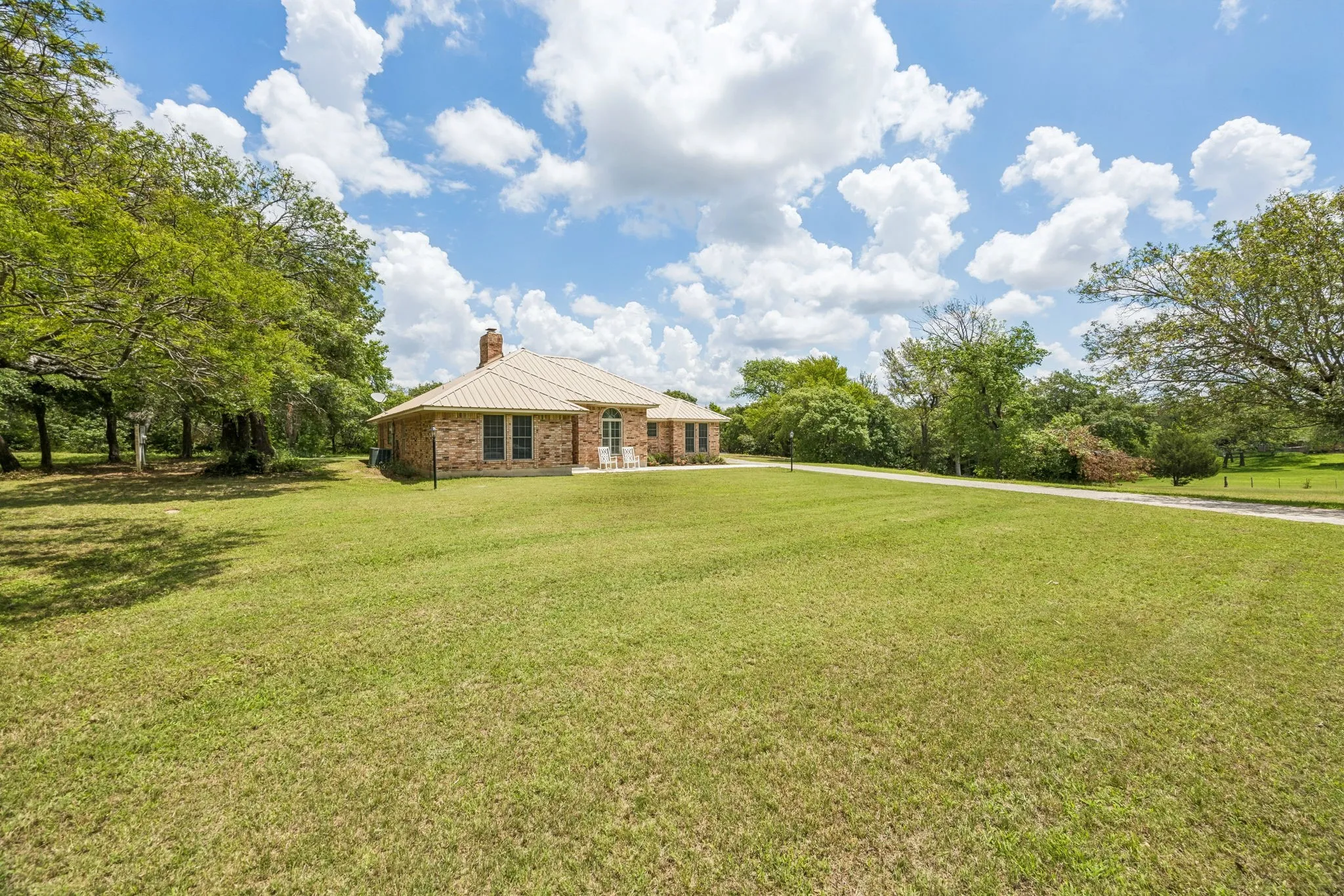 Rolling grassy front lawn provides great space for outdoor activities.