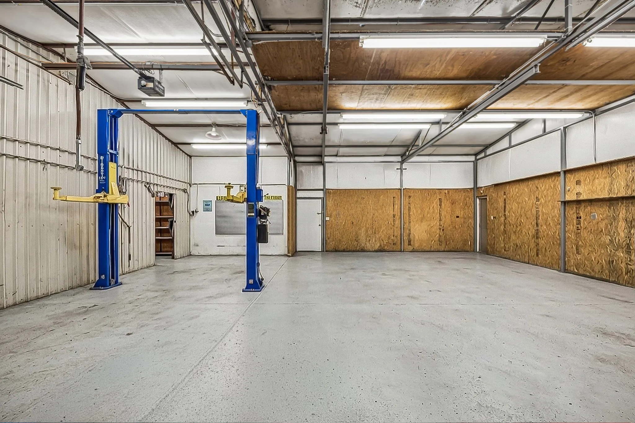 The oversized outbuilding has 14 ft ceilings and is equipped with a professional lift.