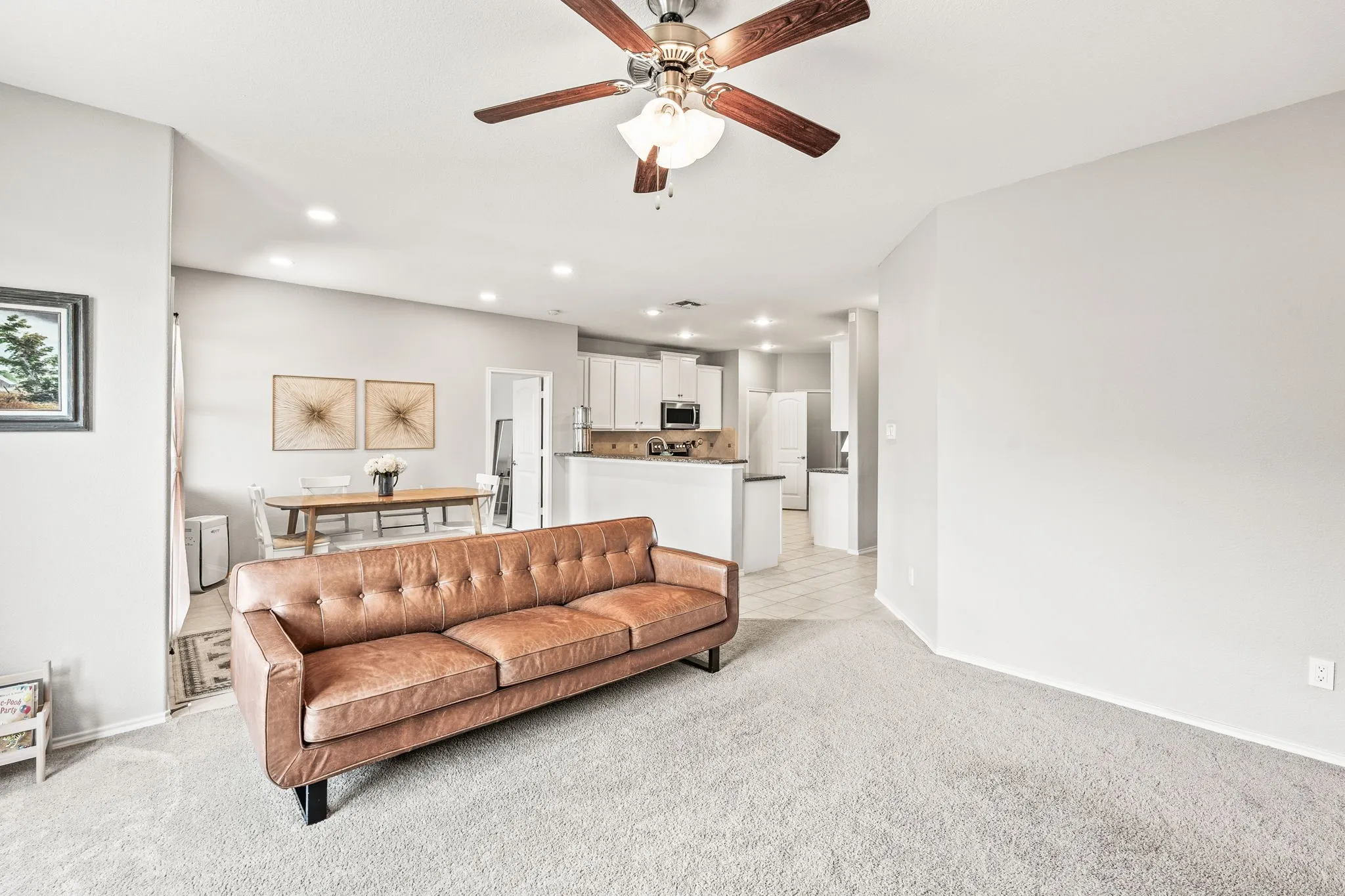 Open-concept living area with light gray walls and recessed lighting
