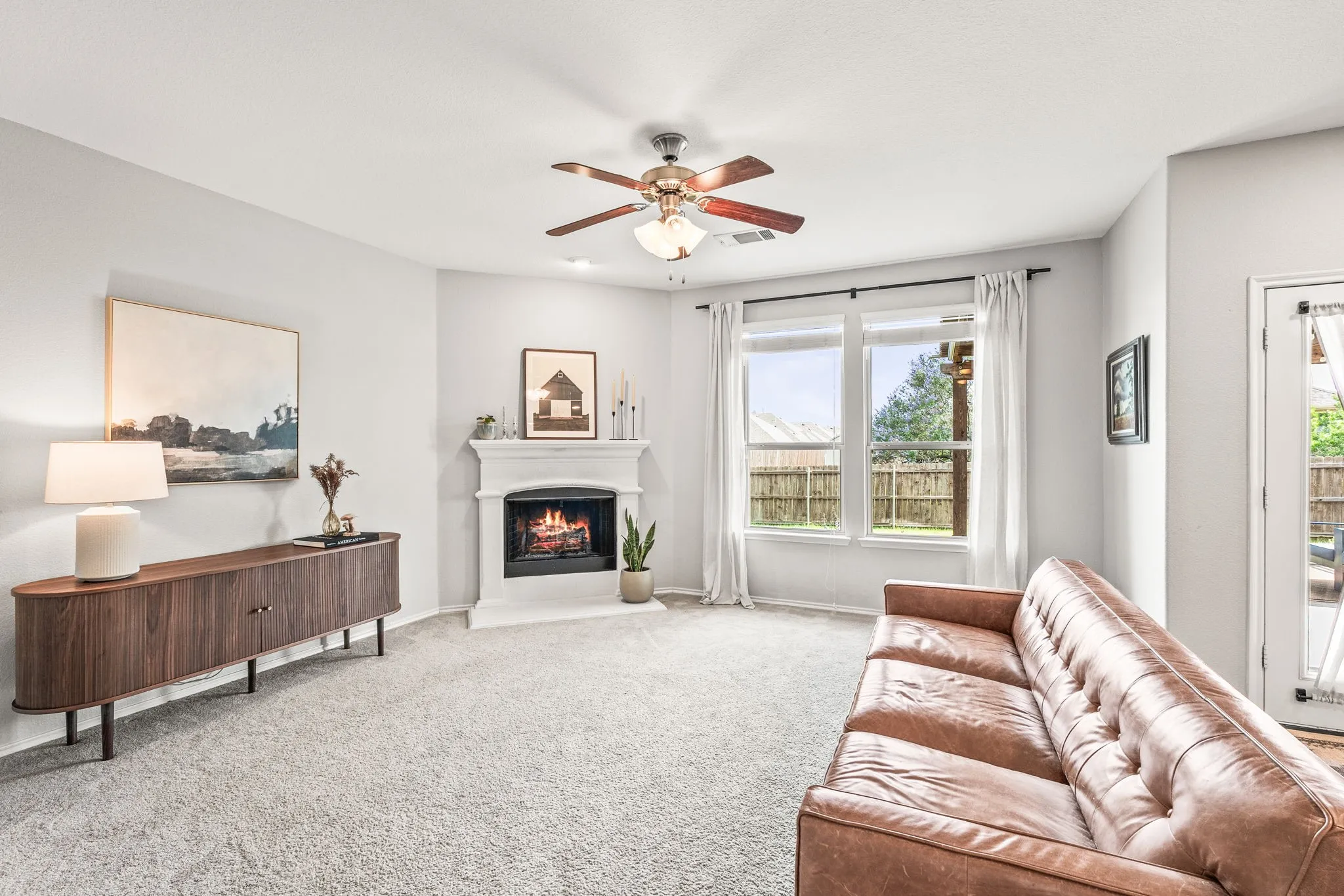 Living space featuring light gray walls and plush carpeting