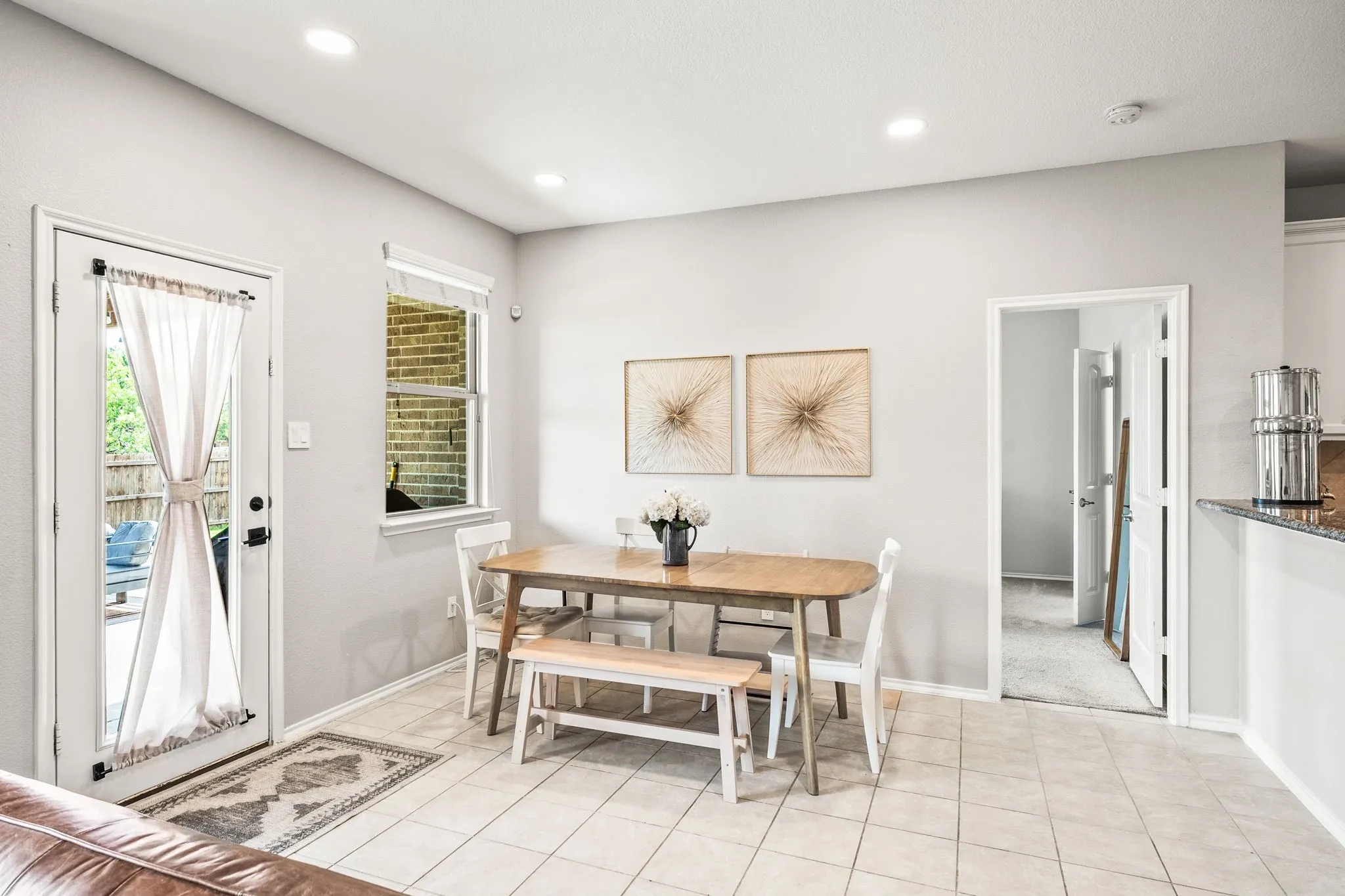 Dining area with tiled flooring, recessed lighting, a single window, and a door providing exterior access
