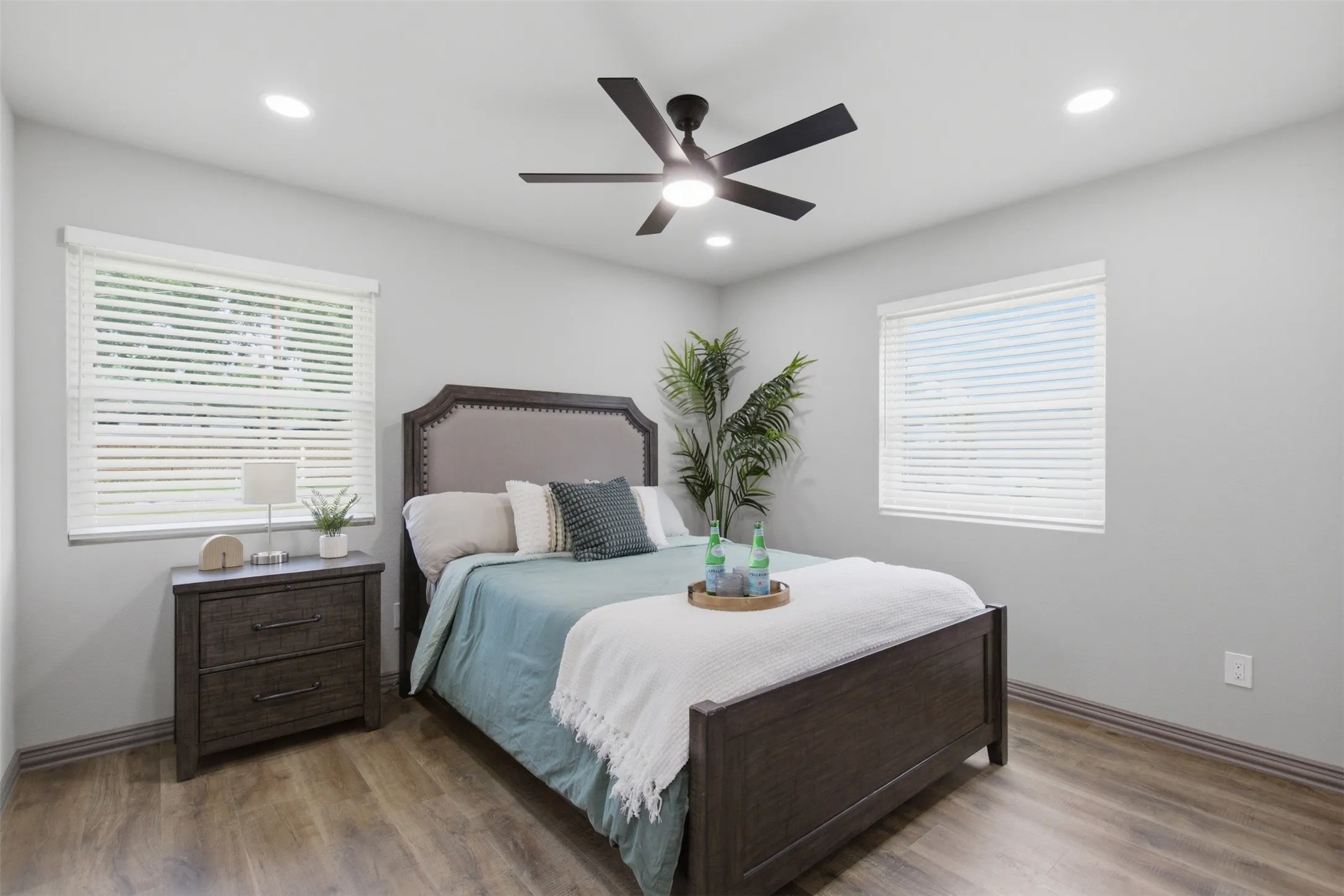 Bedroom featuring light gray walls, wood-finish flooring, and recessed ceiling lights