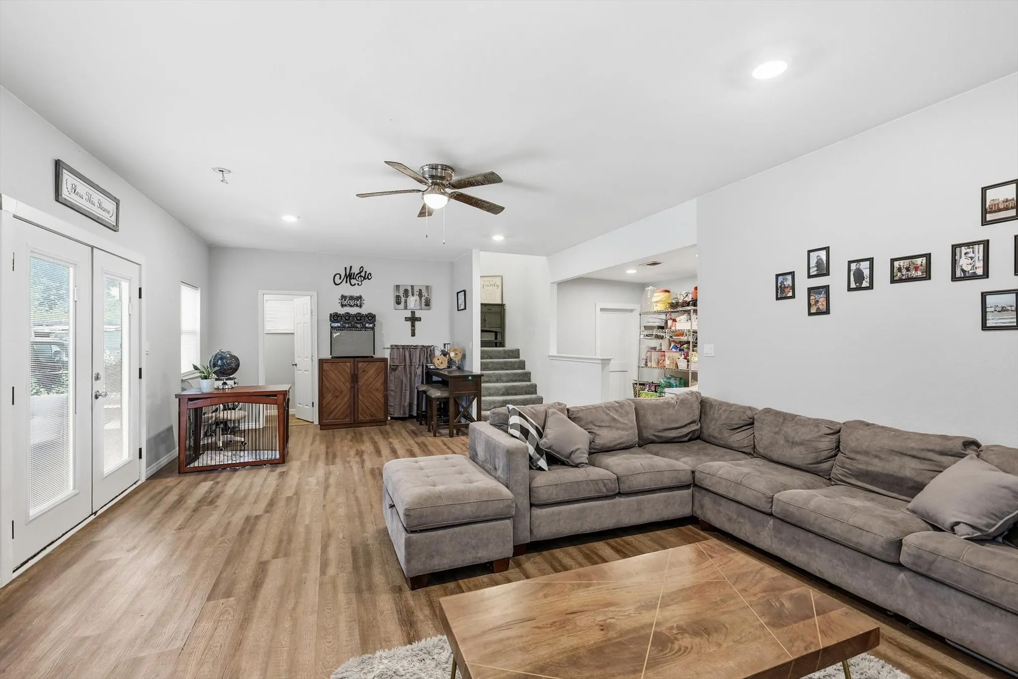 Open concept living area featuring wood-finish flooring, recessed lighting, and a ceiling fan