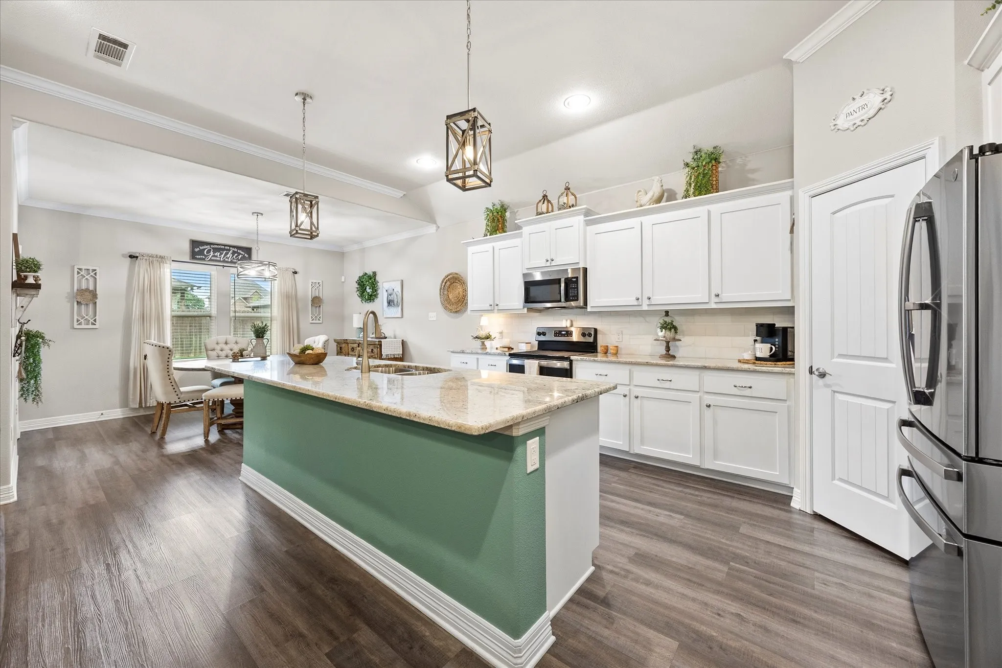 Chef's dream kitchen includes center island/breakfast bar and opens onto dining area.