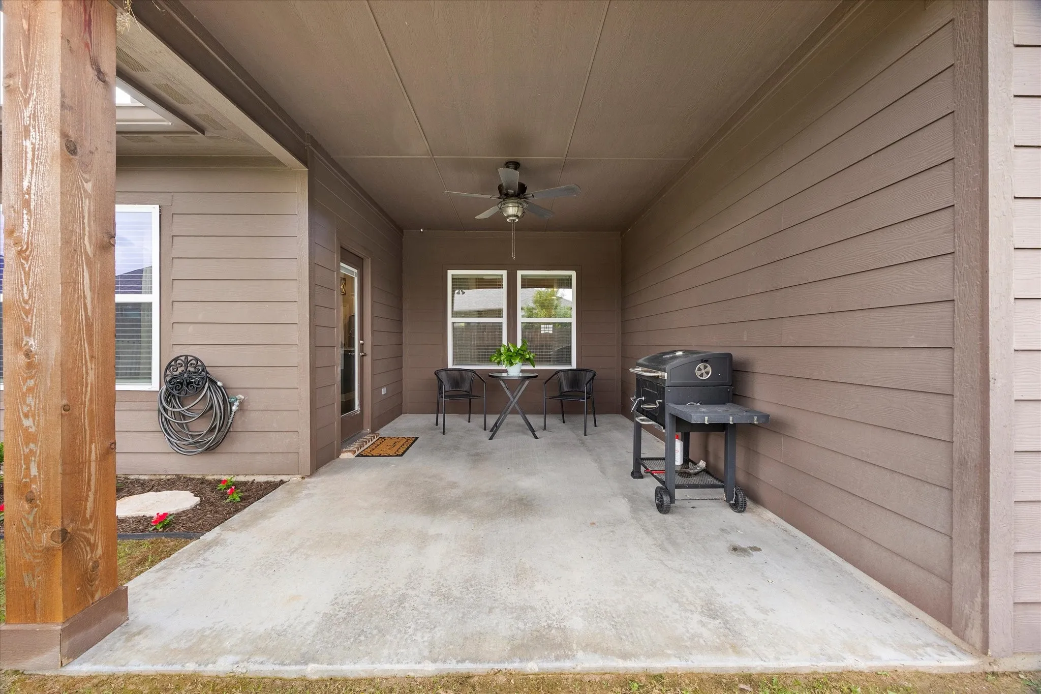 Extended patio overlooks fenced back yard