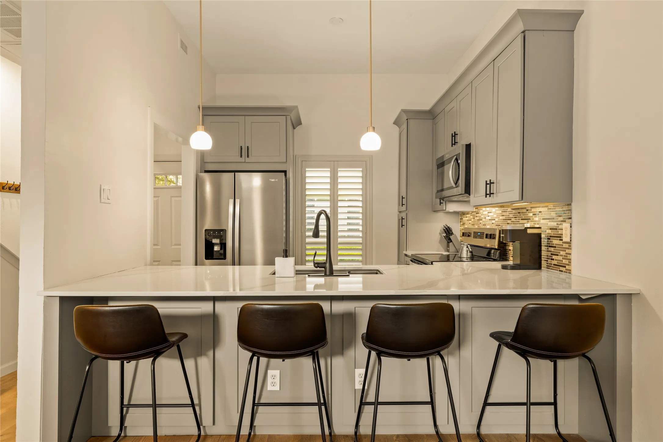 Fully redesigned kitchen with custom cabinetry and quartz countertops.