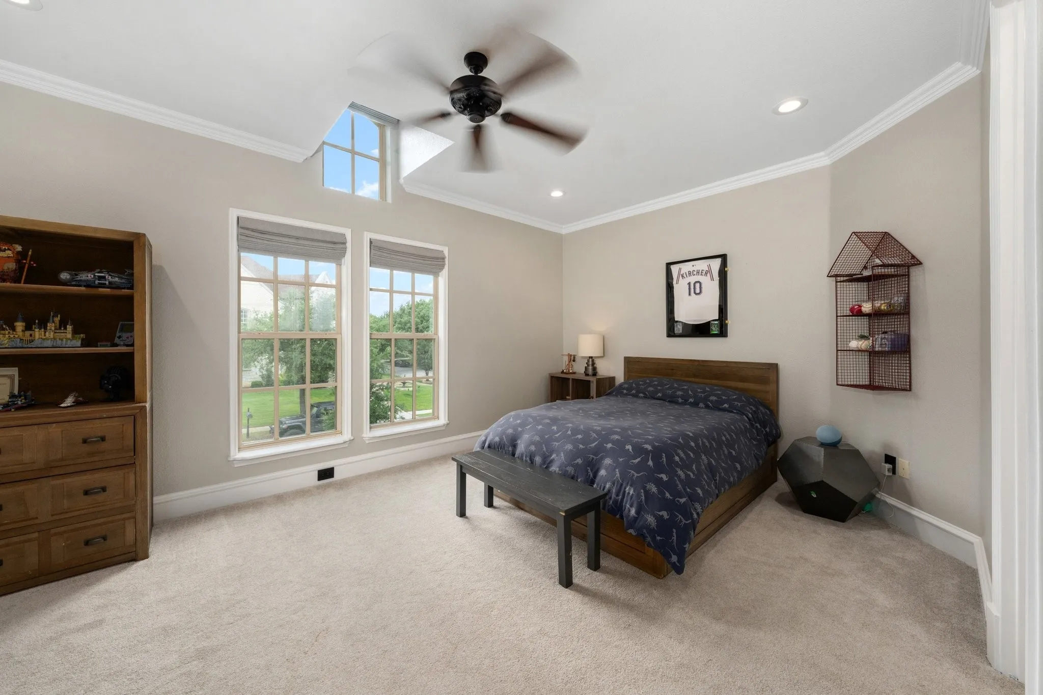 Bedroom featuring plush carpeting, two large windows, a transom window, a ceiling fan, and recessed lighting